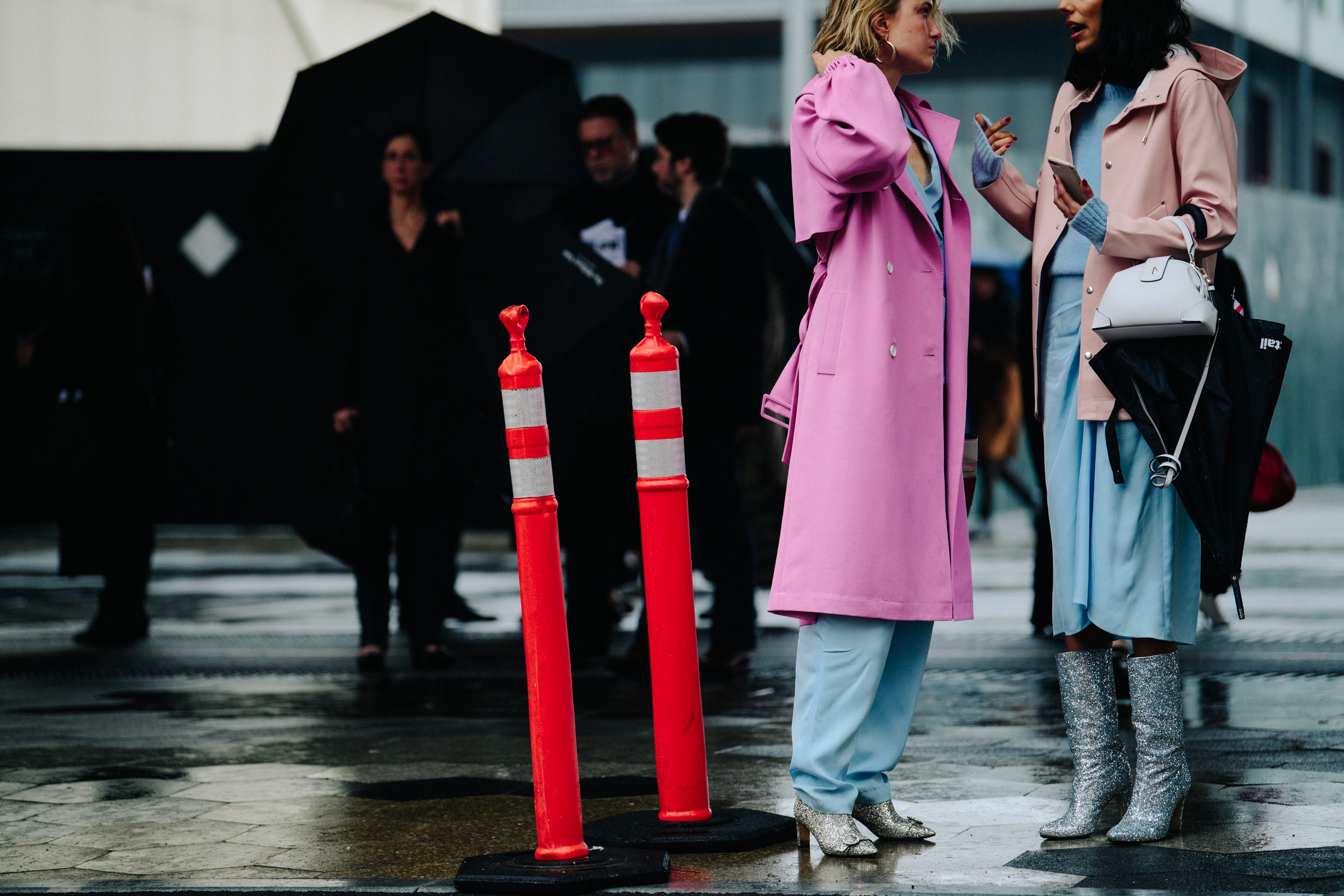 Two women wearing pink coats