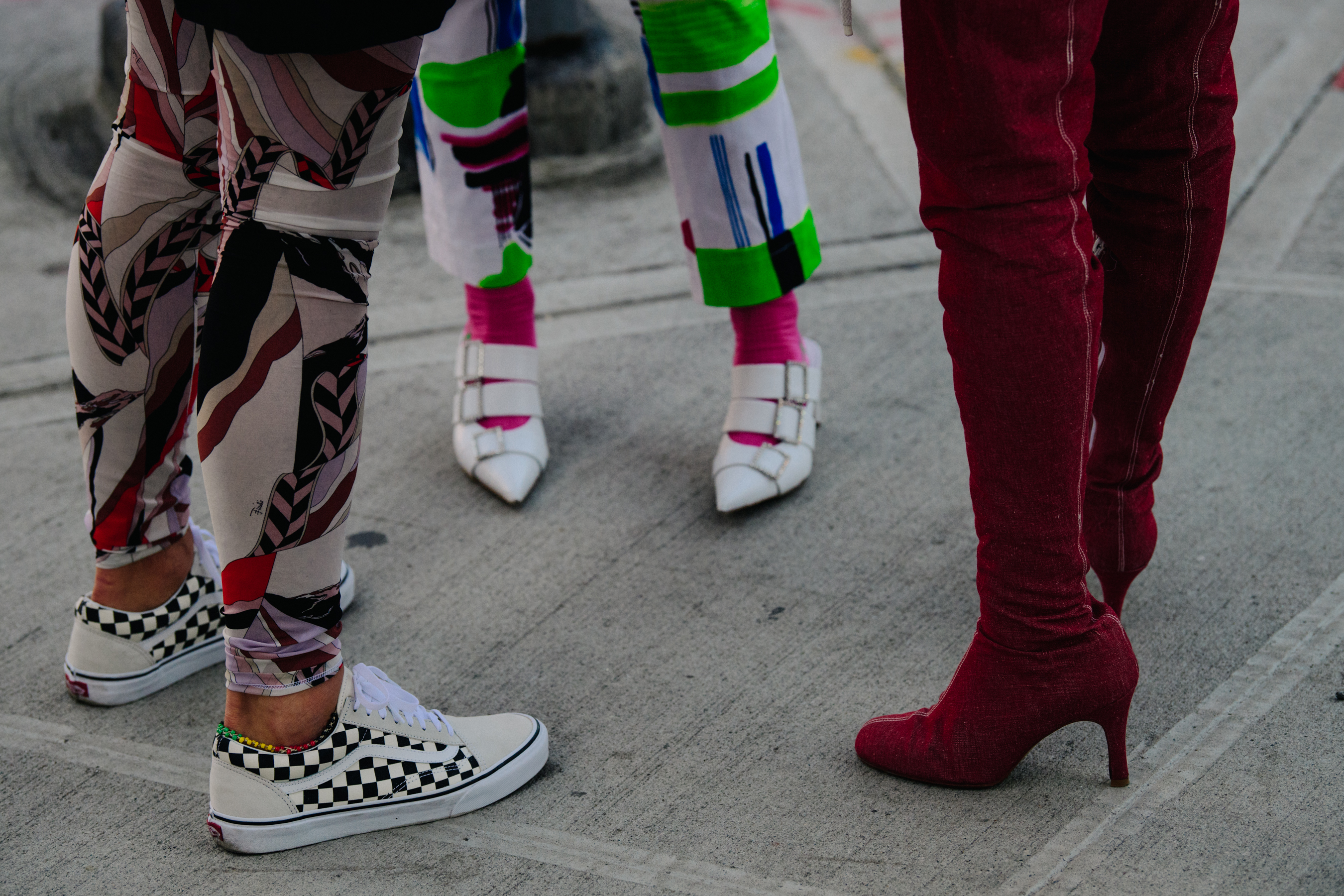 Three people wearing colourful shoes