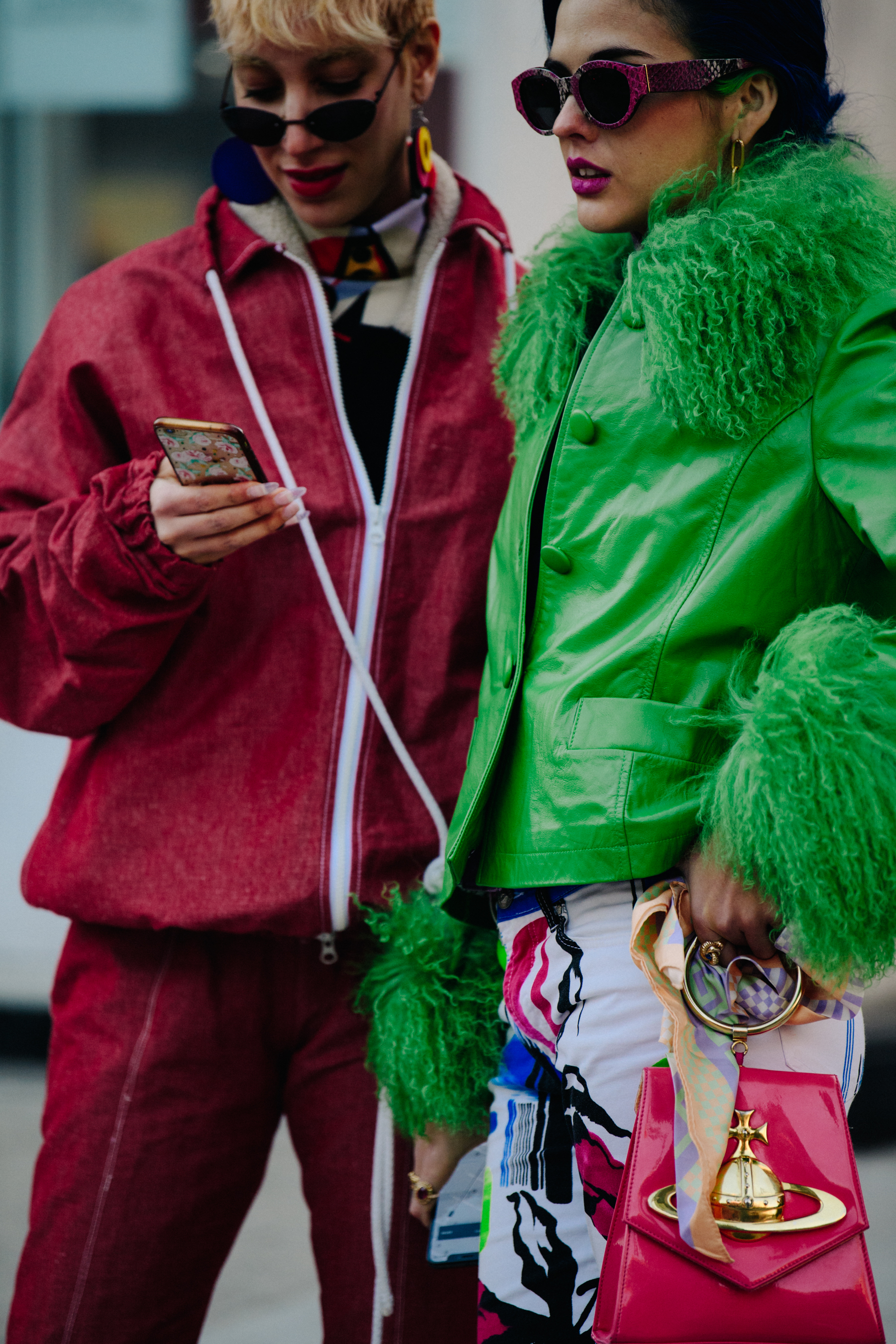 Two women wearing pink and green