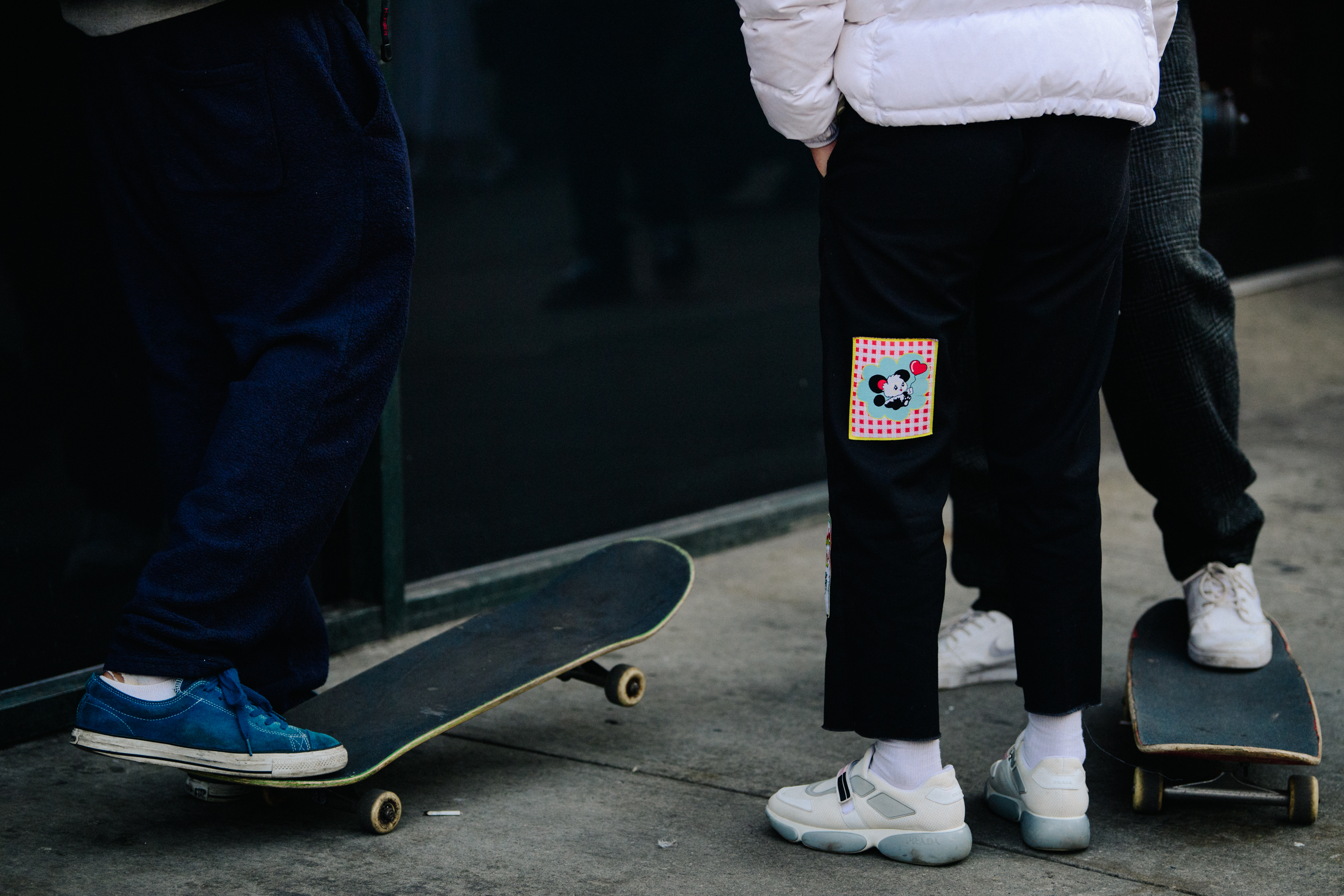Skateboarders wearing white sneakers