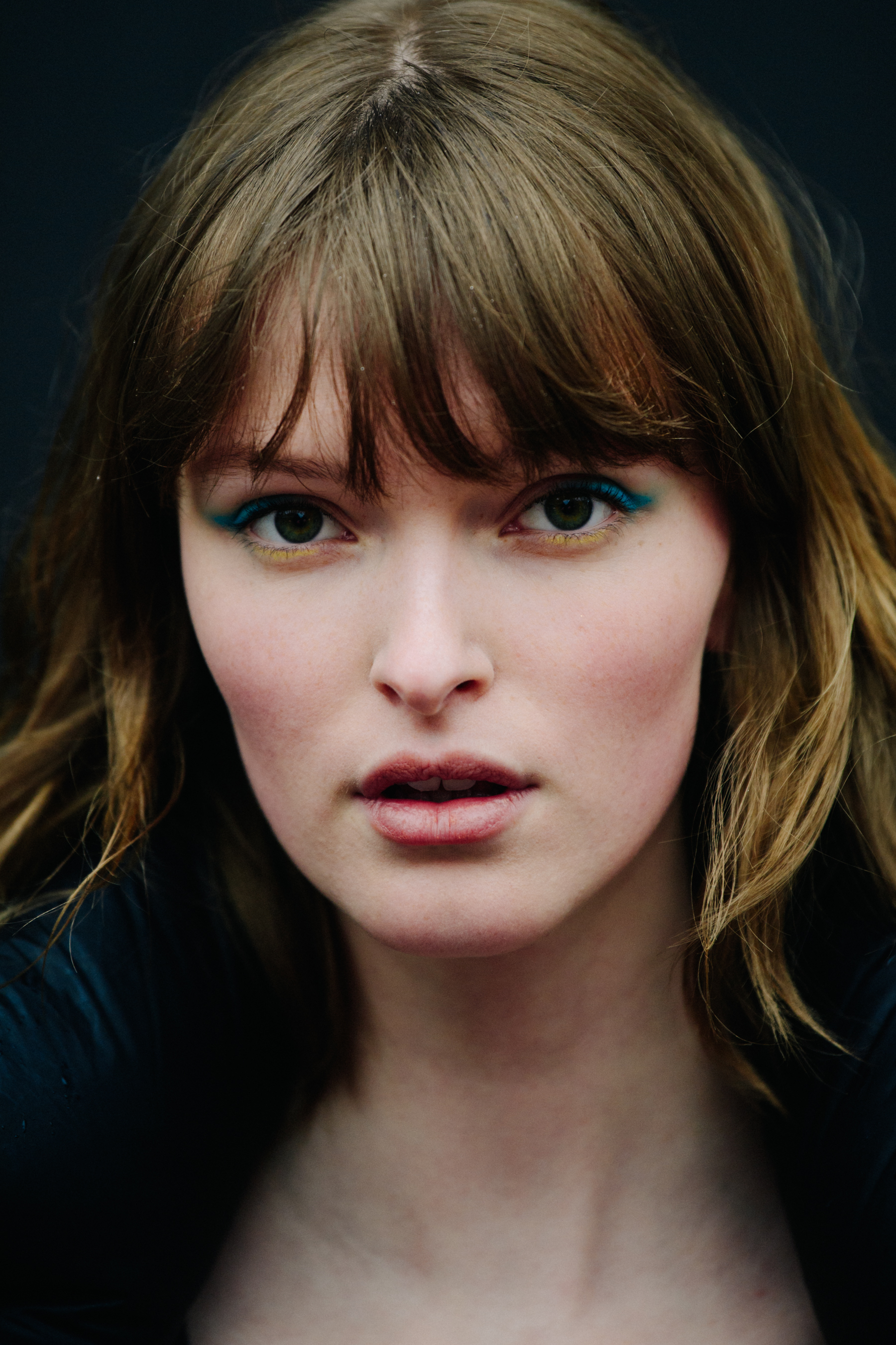 Portrait of model with blue and yellow eye makeup