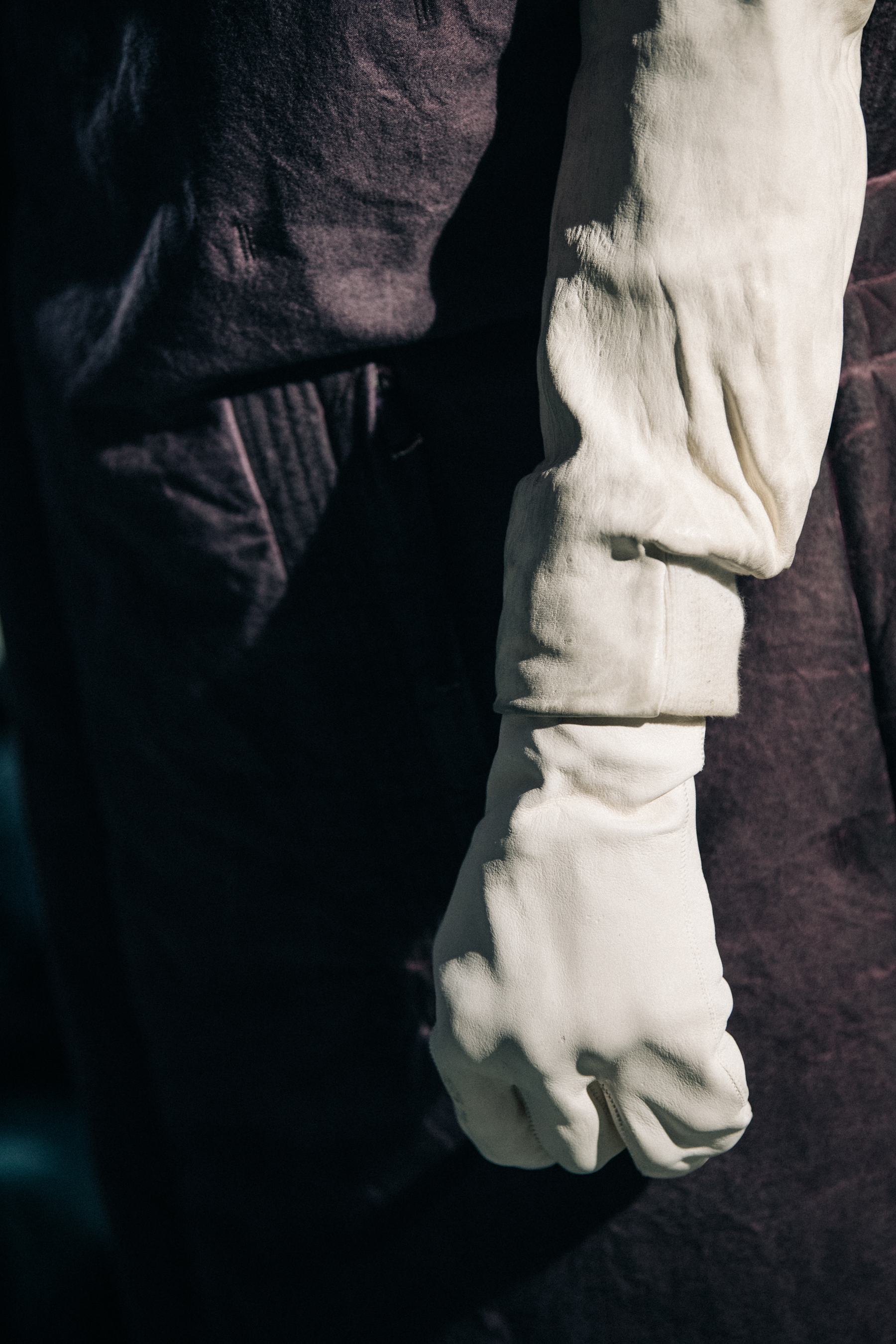Model wearing grey and purple backstage