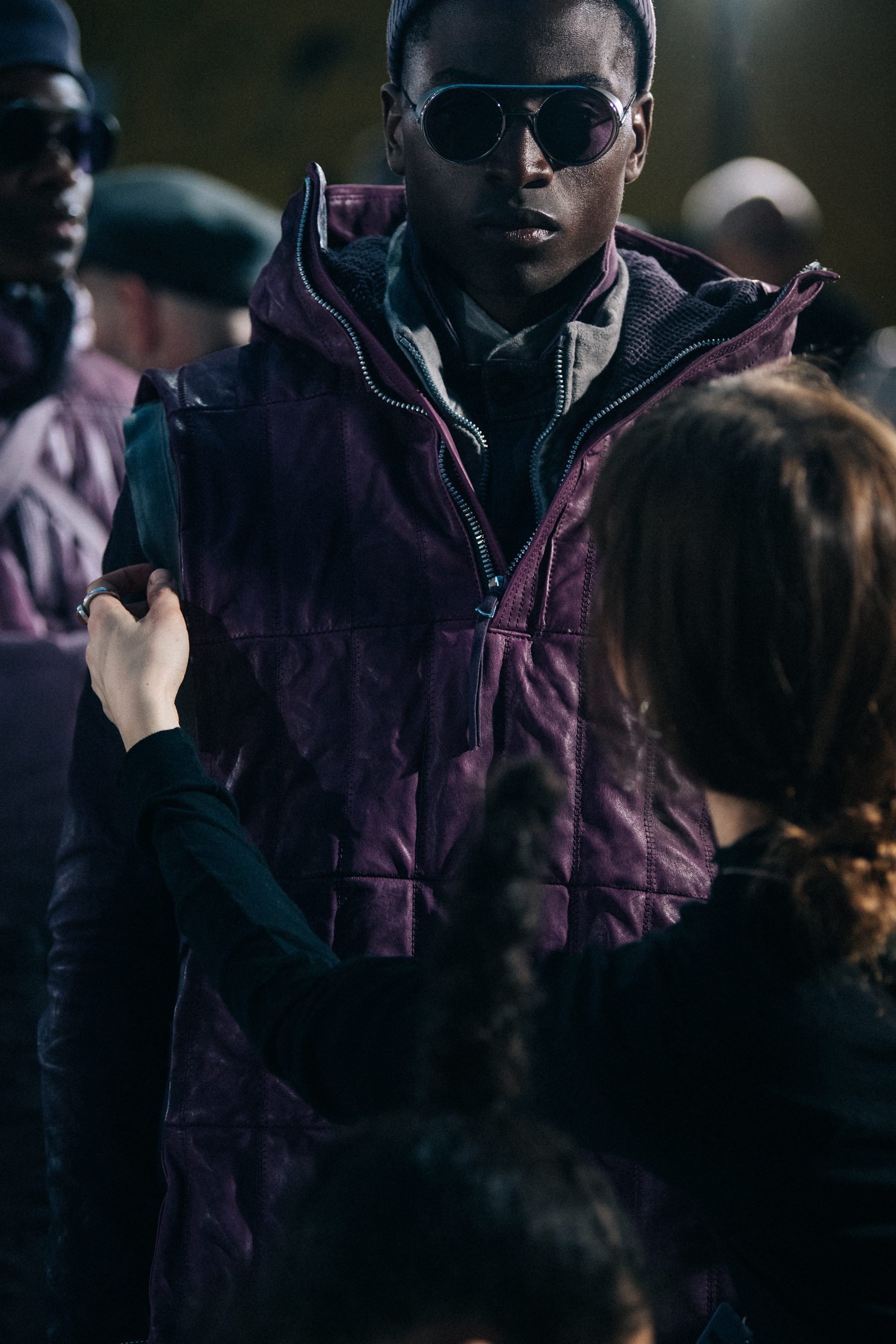 Models wearing grey and purple backstage