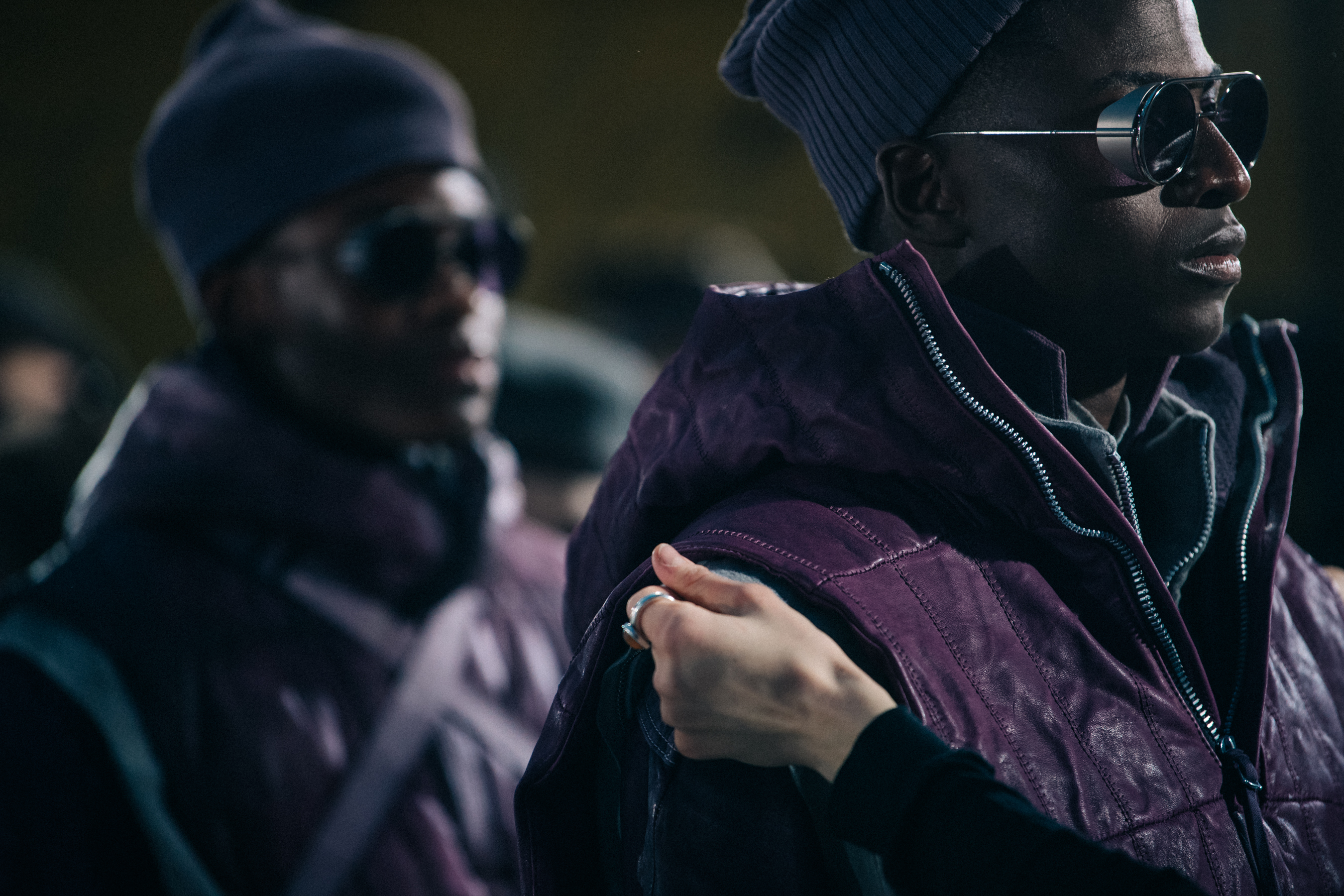 Models wearing grey and purple backstage
