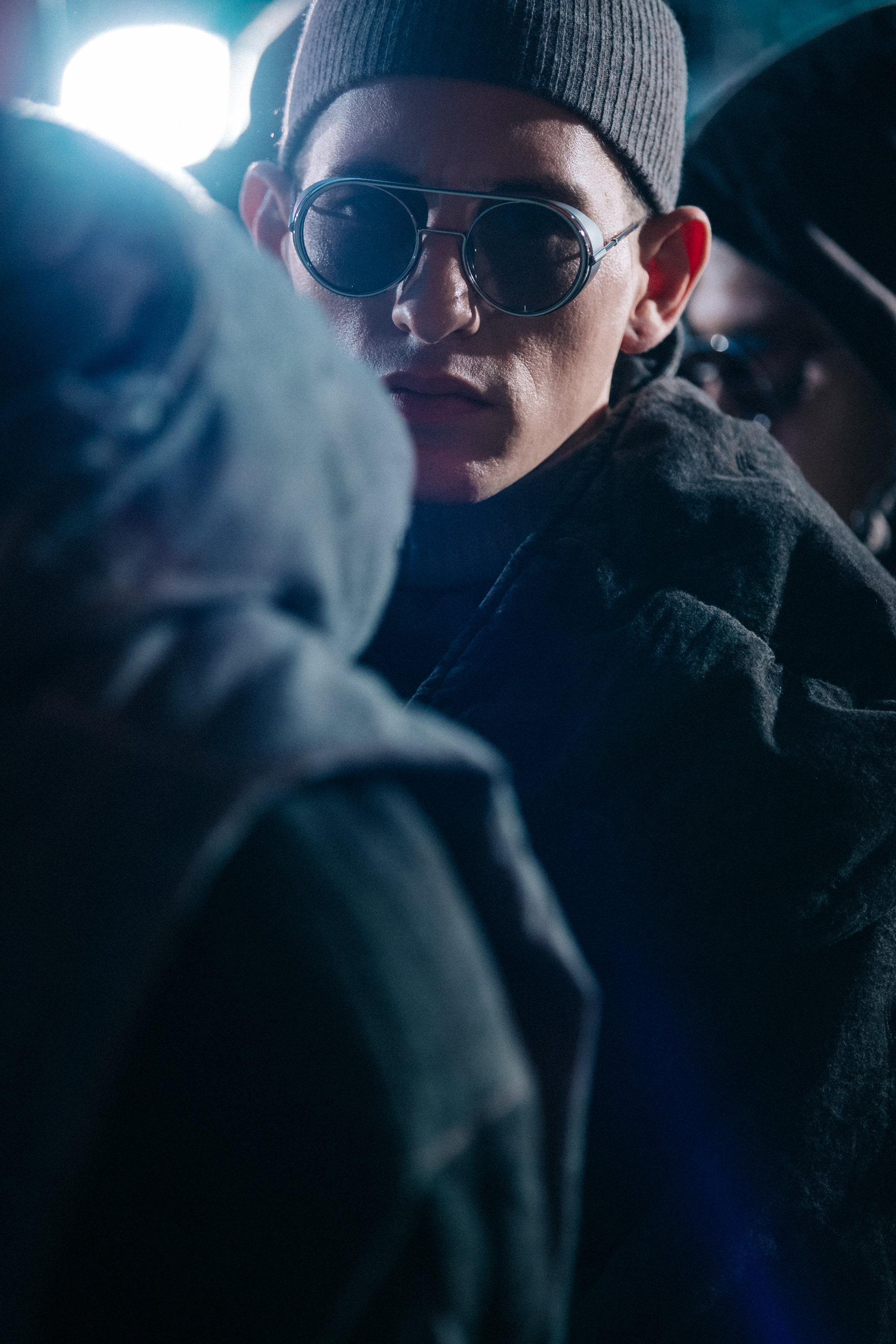 Model wearing round glasses backstage