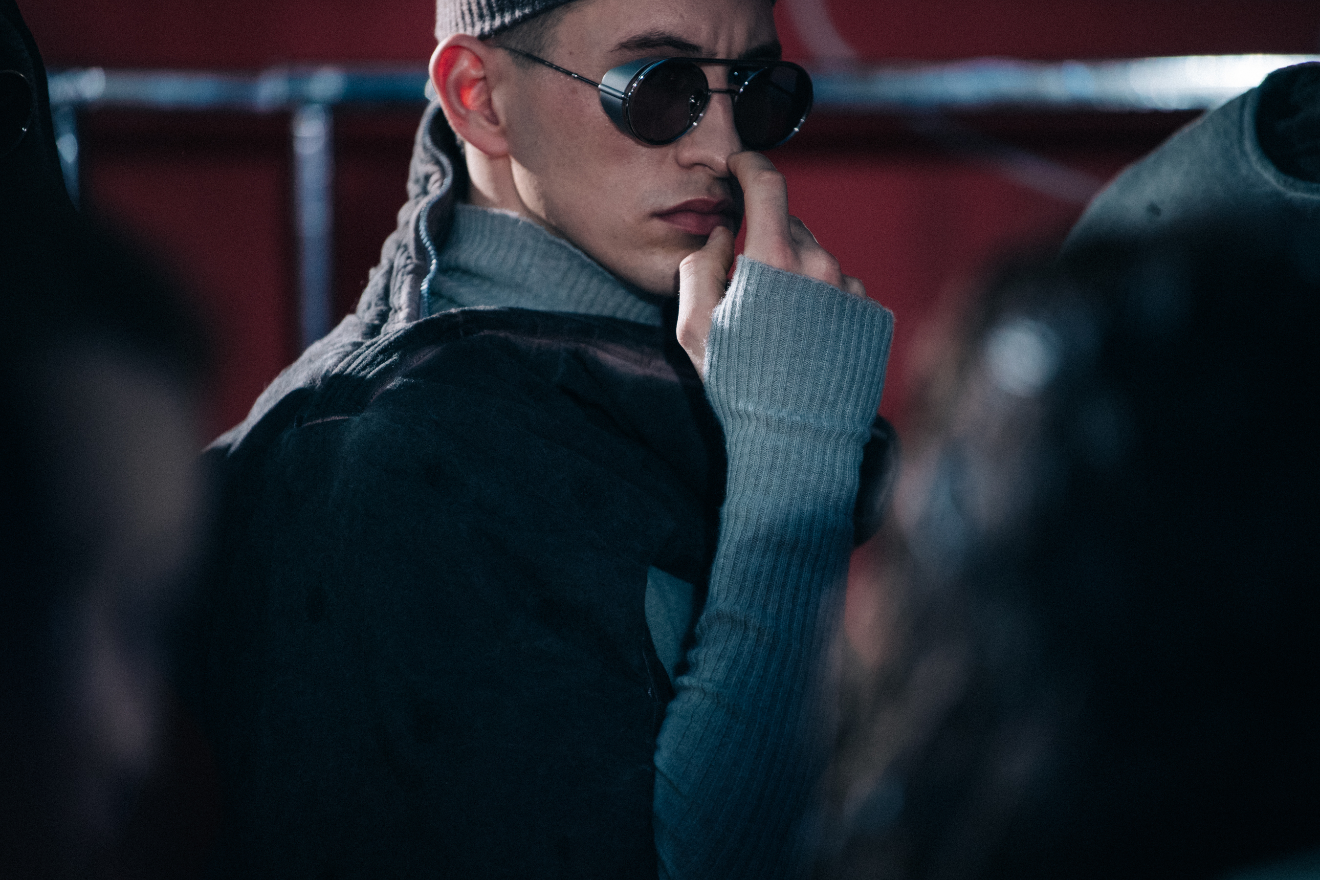 Model wearing round glasses backstage