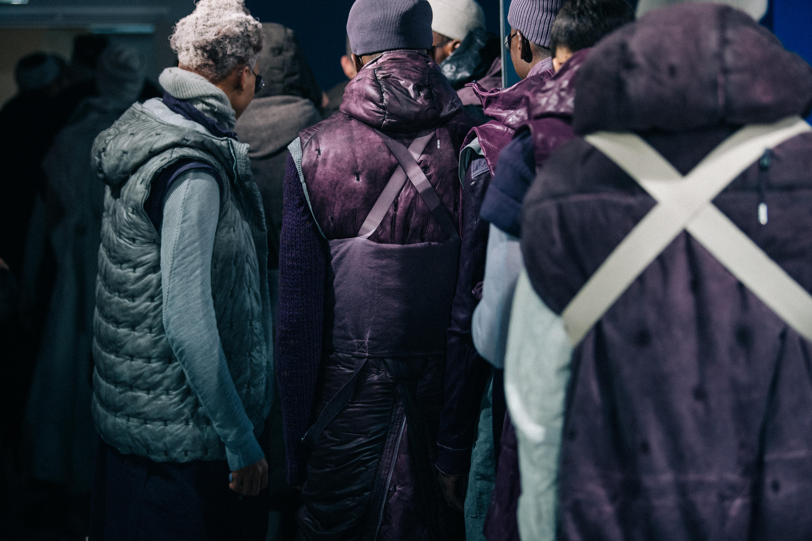 Models wearing grey and purple backstage