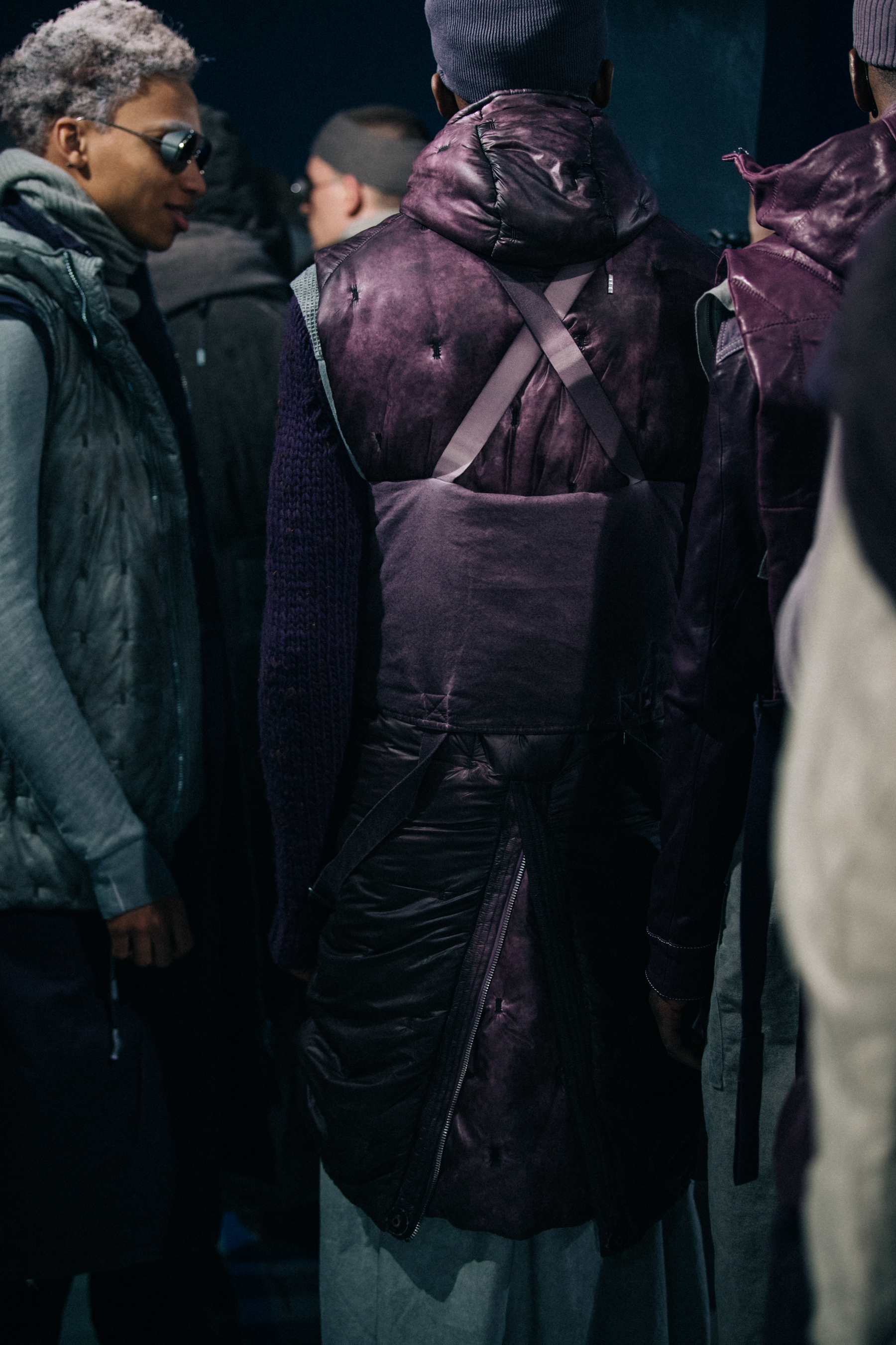 Models wearing grey and purple backstage