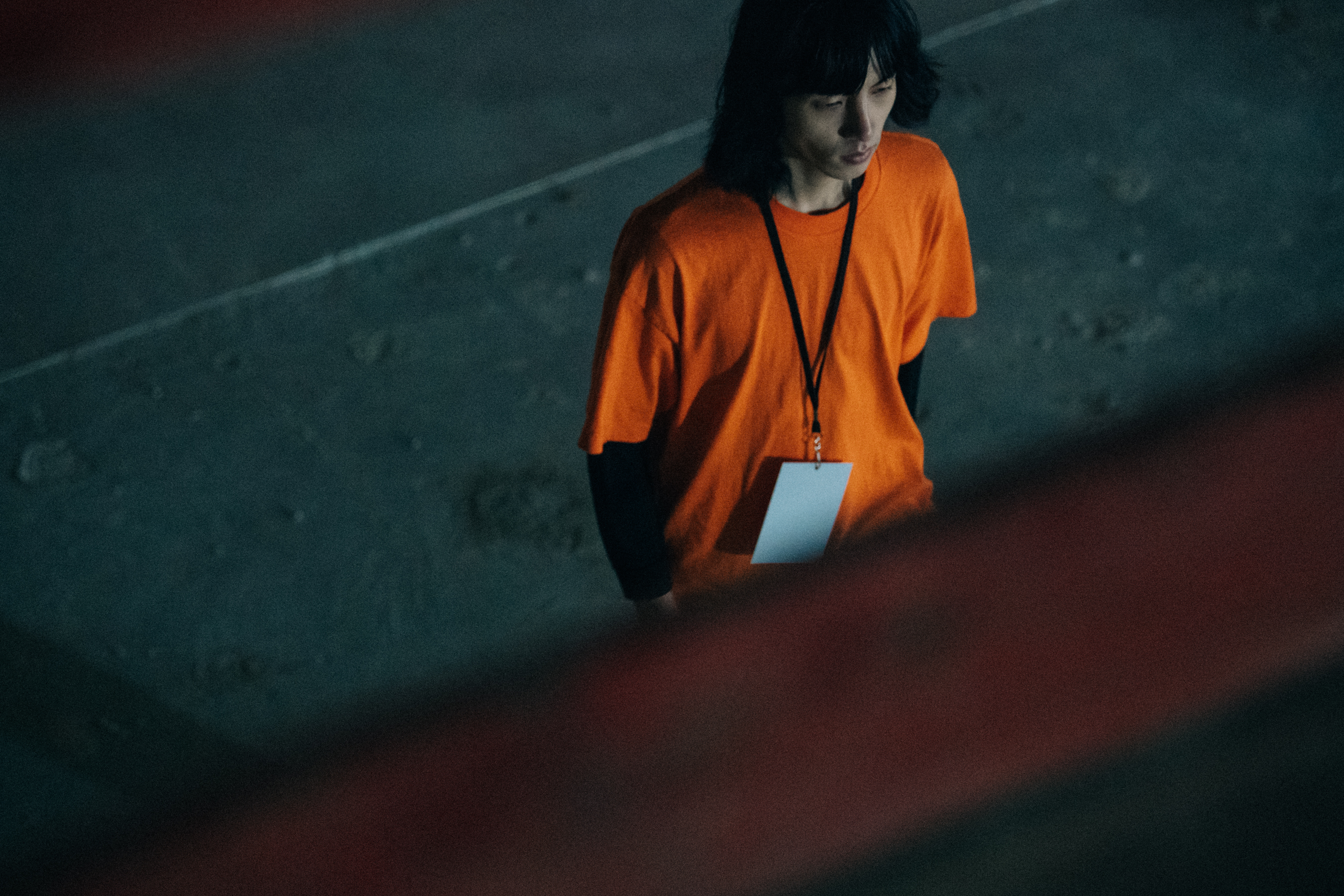 Model wearing orange backstage at Etudes Studio