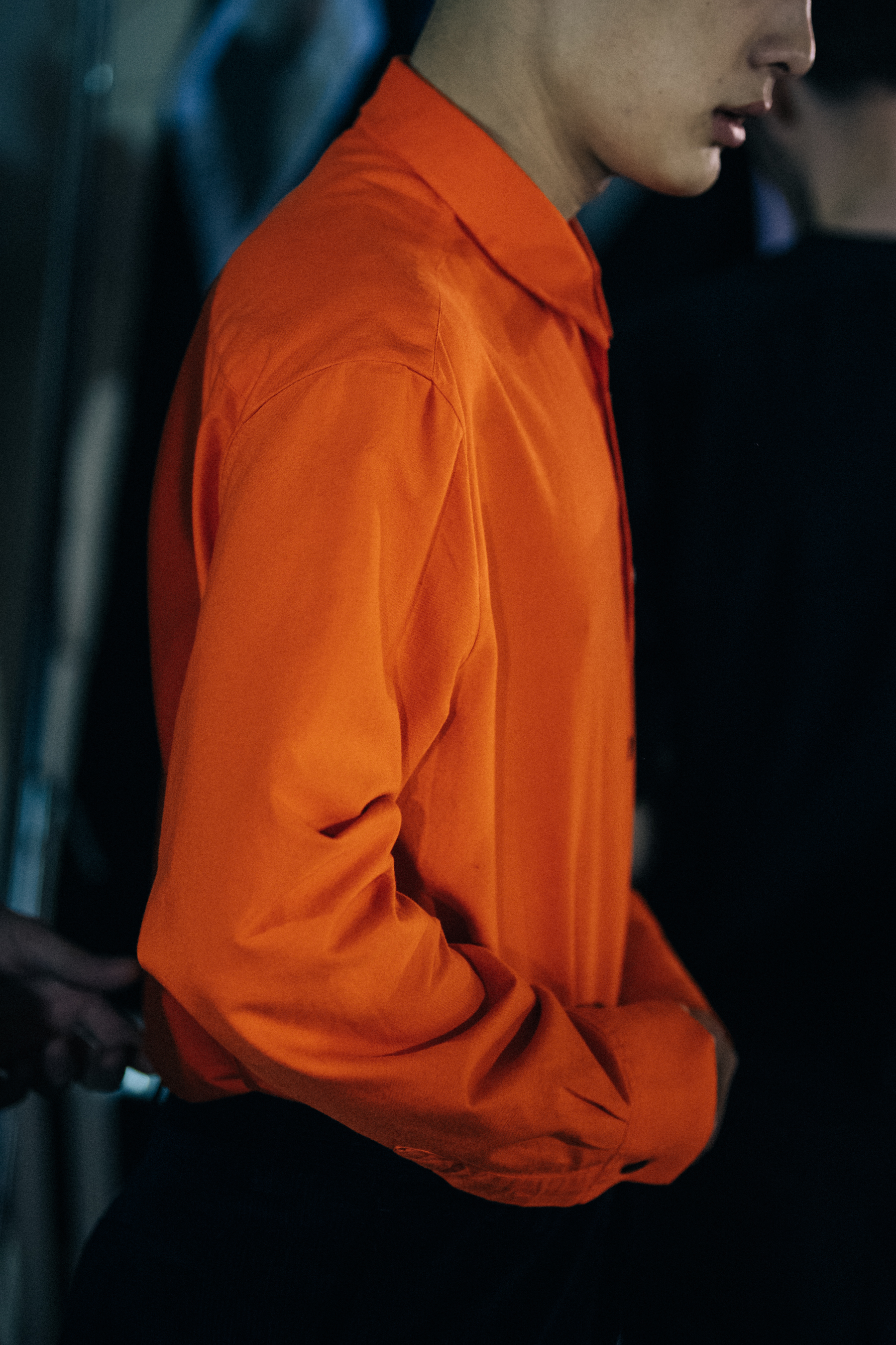 Model wearing orange backstage at Etudes Studio