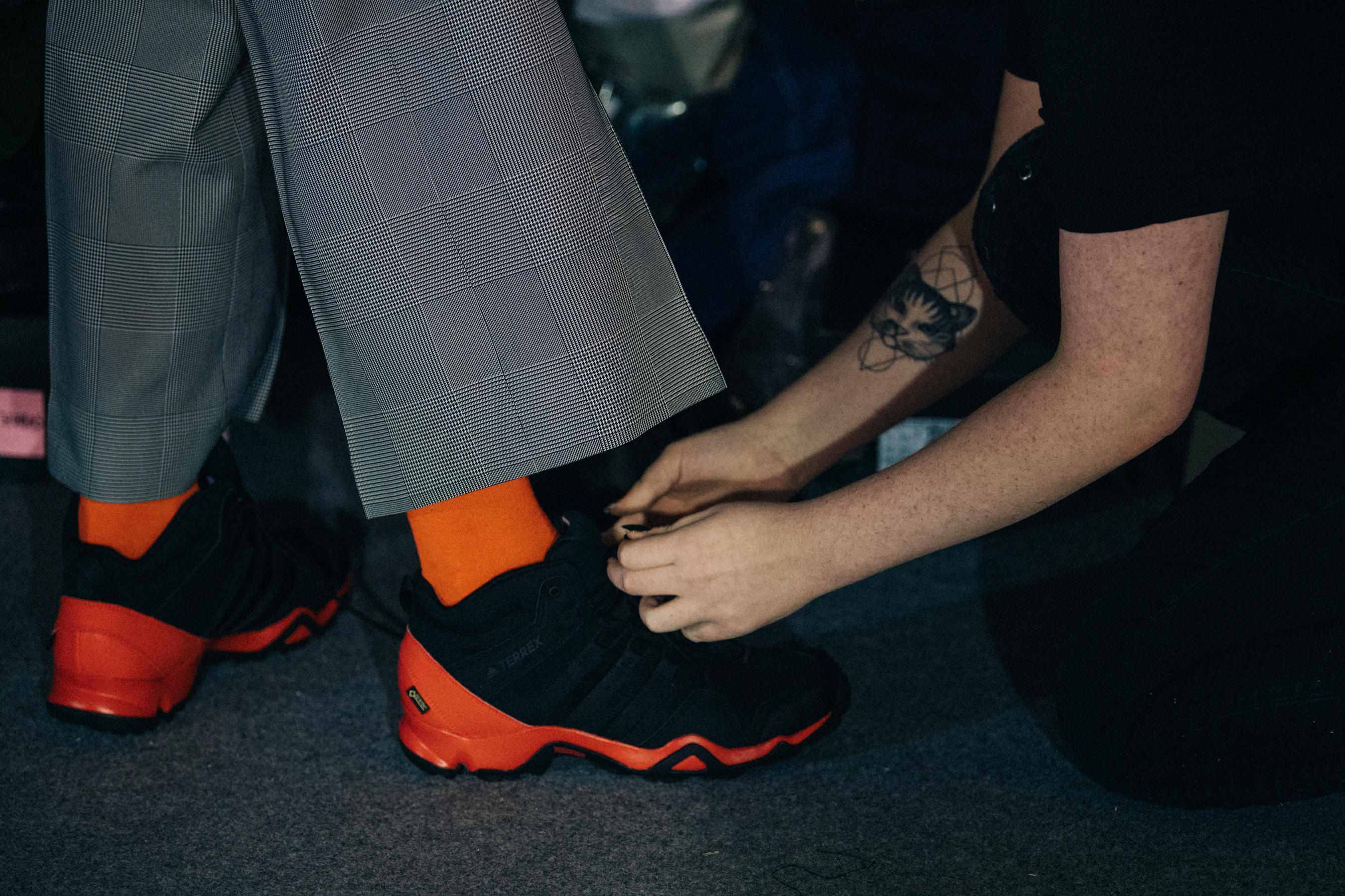 Model wearing Adidas sneakers
