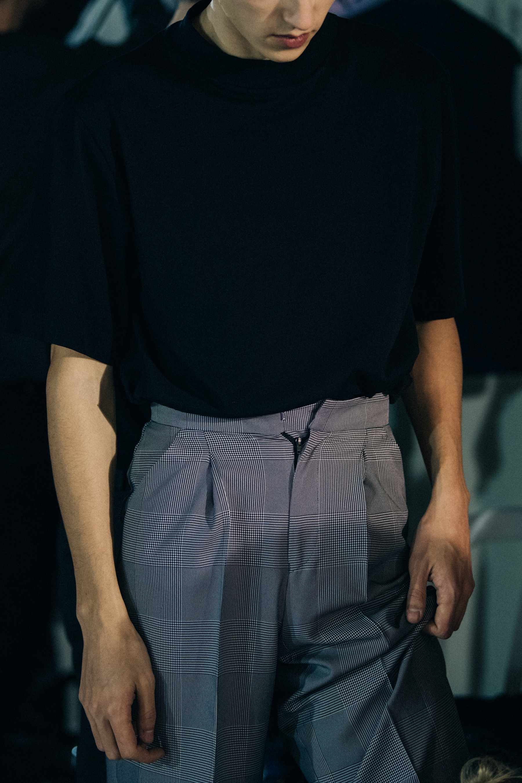 Model wearing grey suit trousers