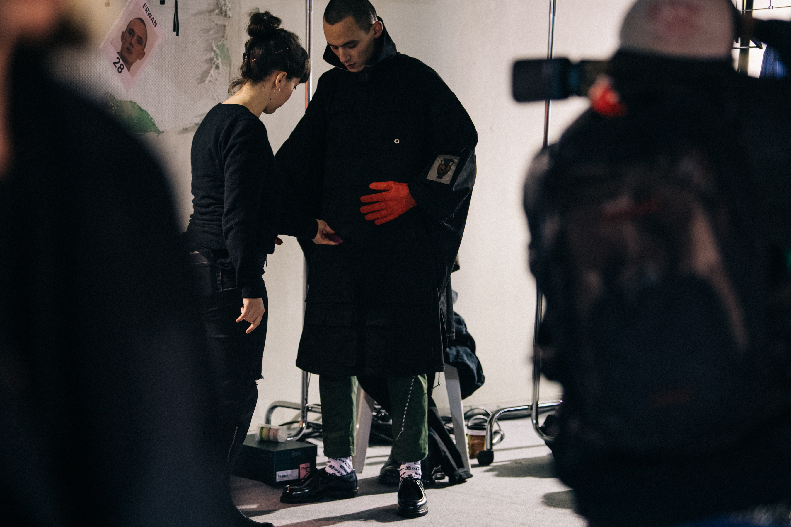 Model wearing orange Etudes Studio gloves