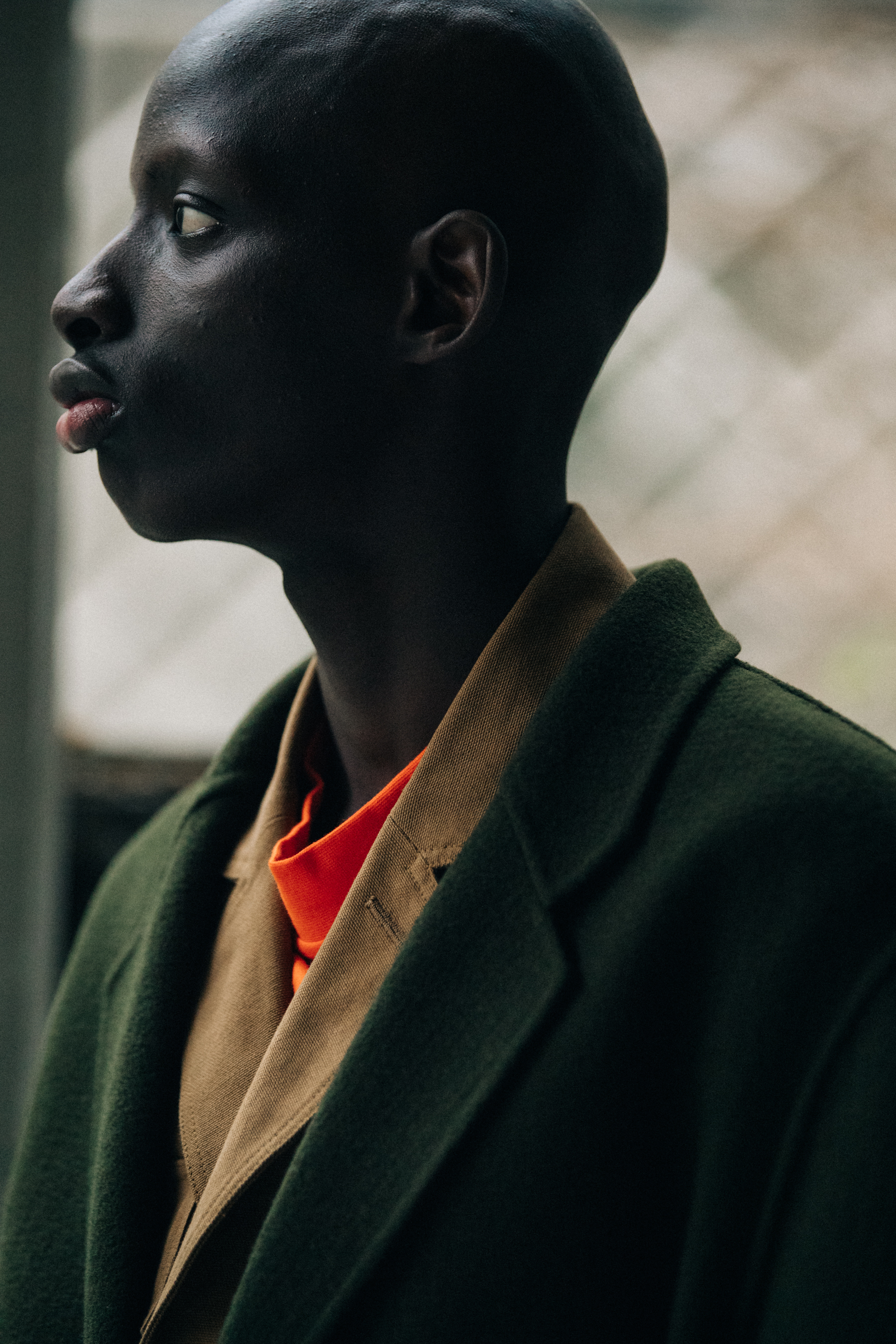 Model wearing green belted coat