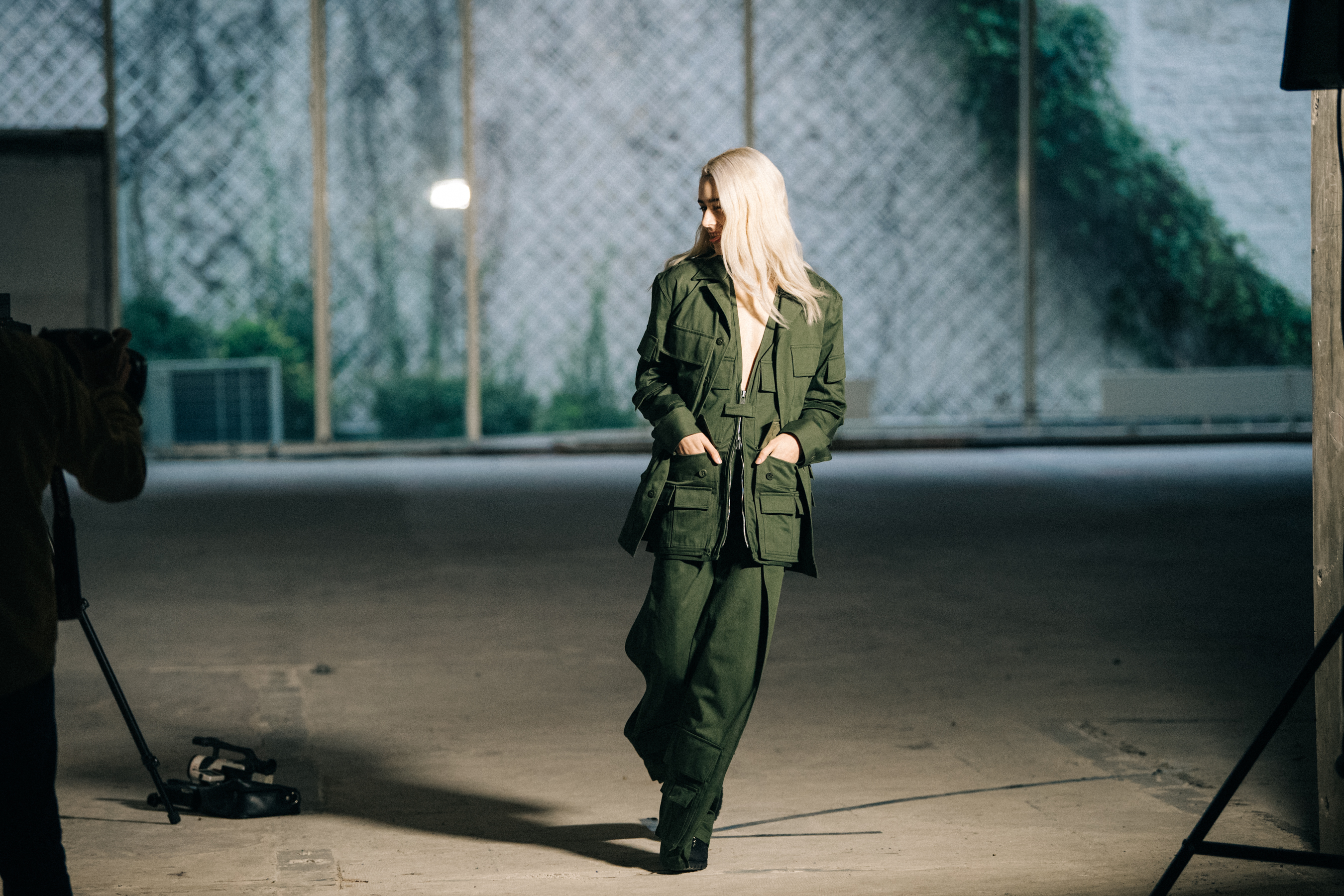 Model on runway wearing green outfit