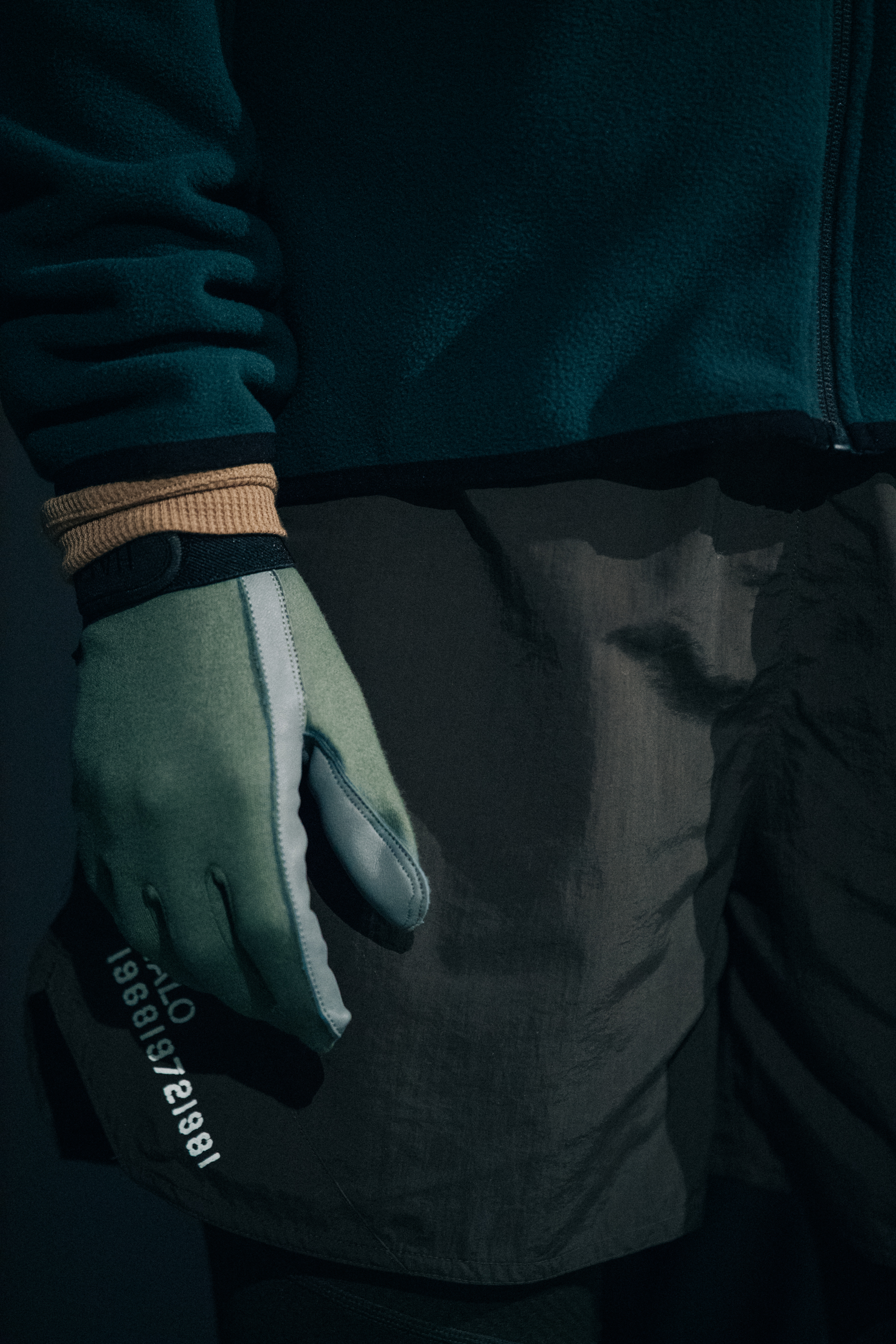 Model wearing green fleece and gloves