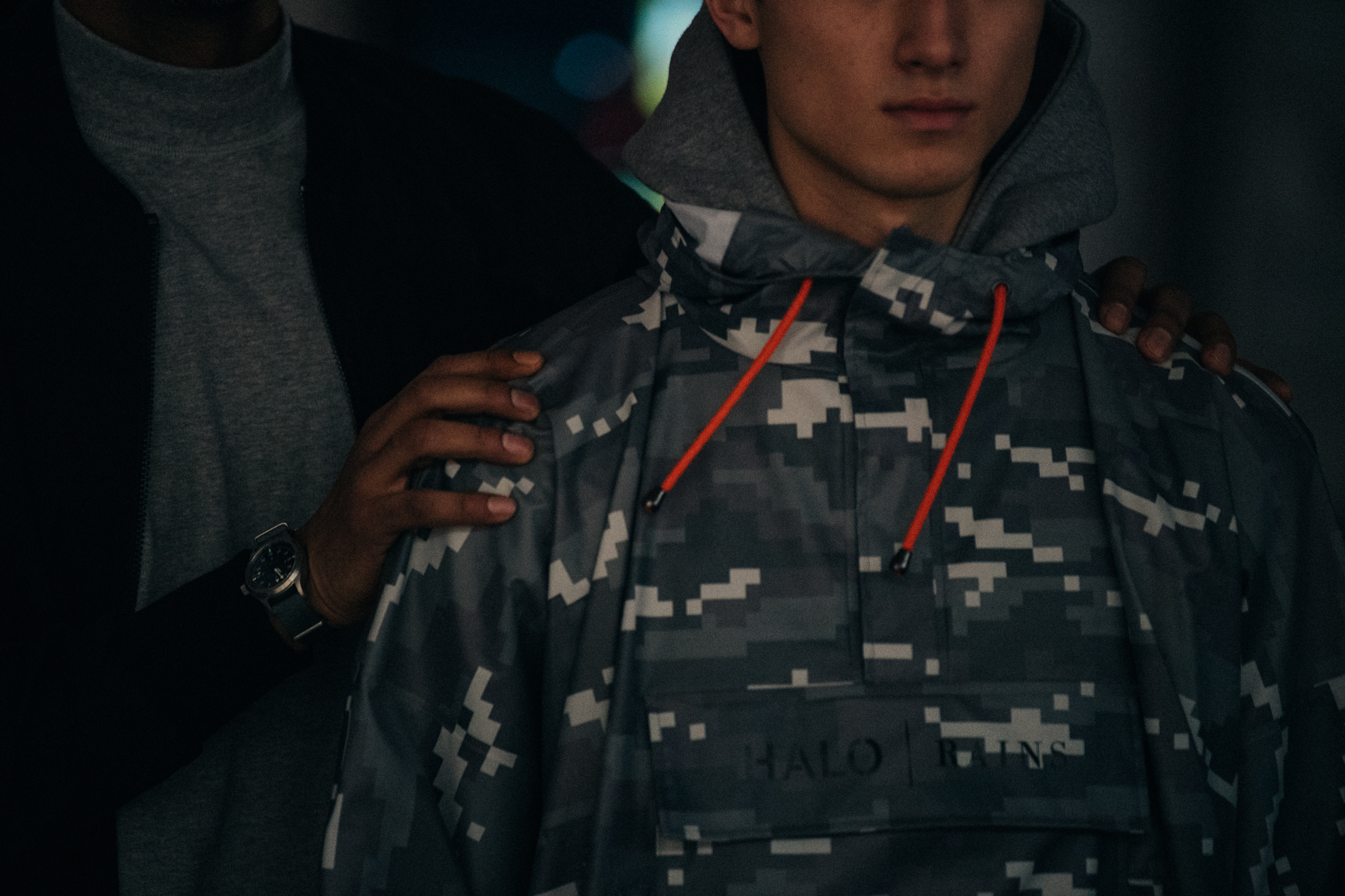 Model wearing grey digital camouflage backstage