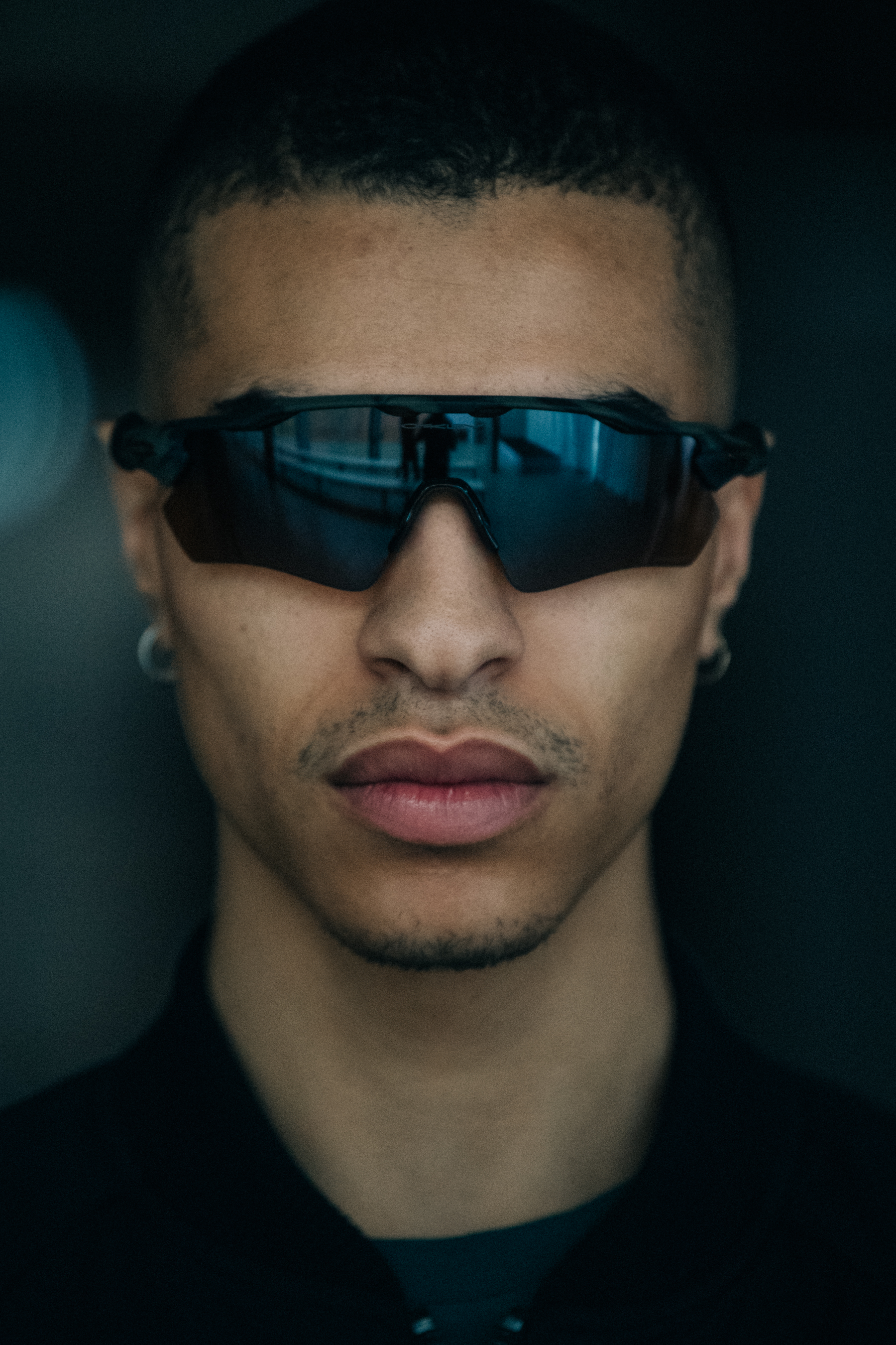 Portrait of model wearing black Oakley glasses