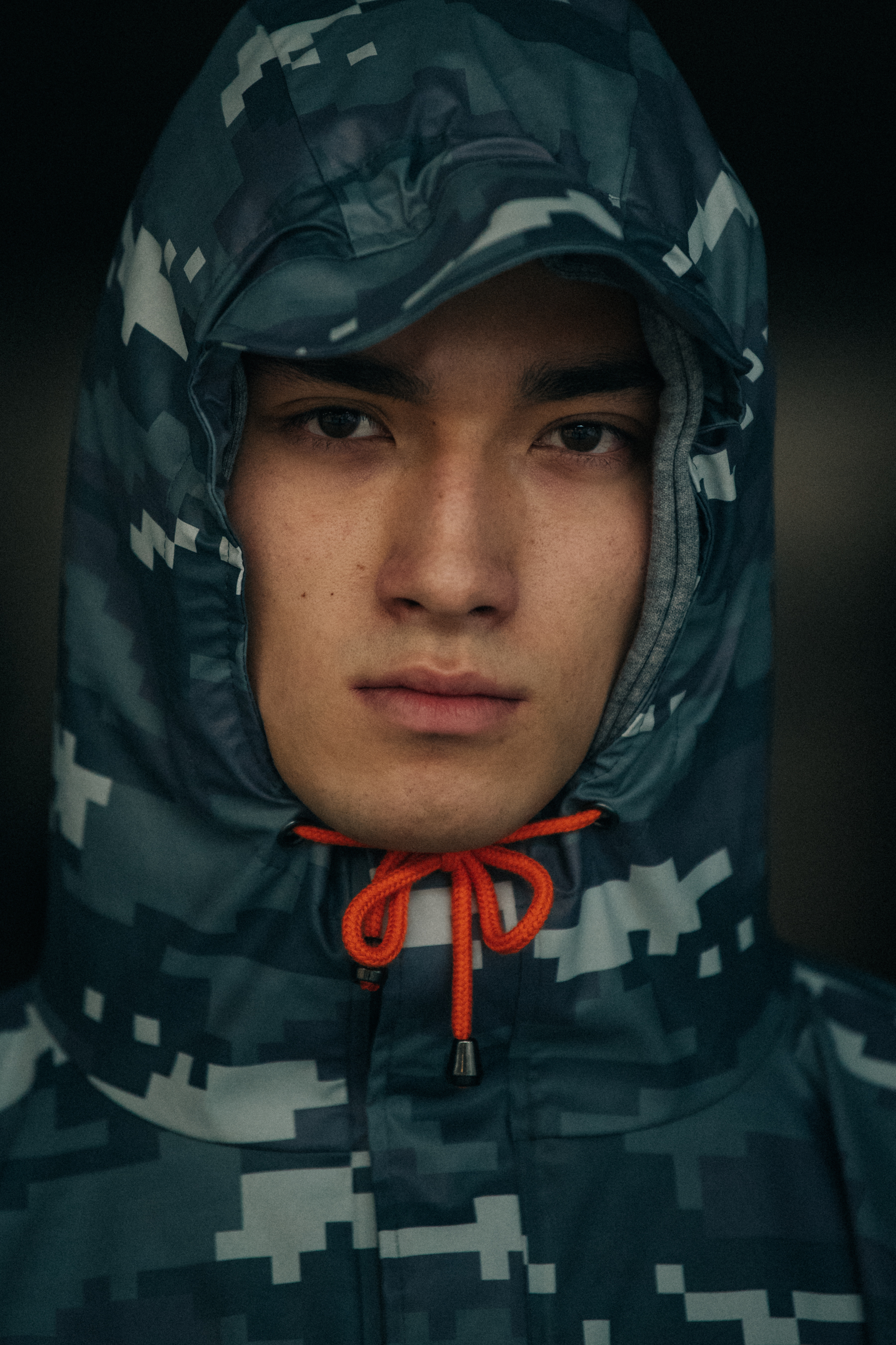 Portrait of model wearing camouflage hoodie