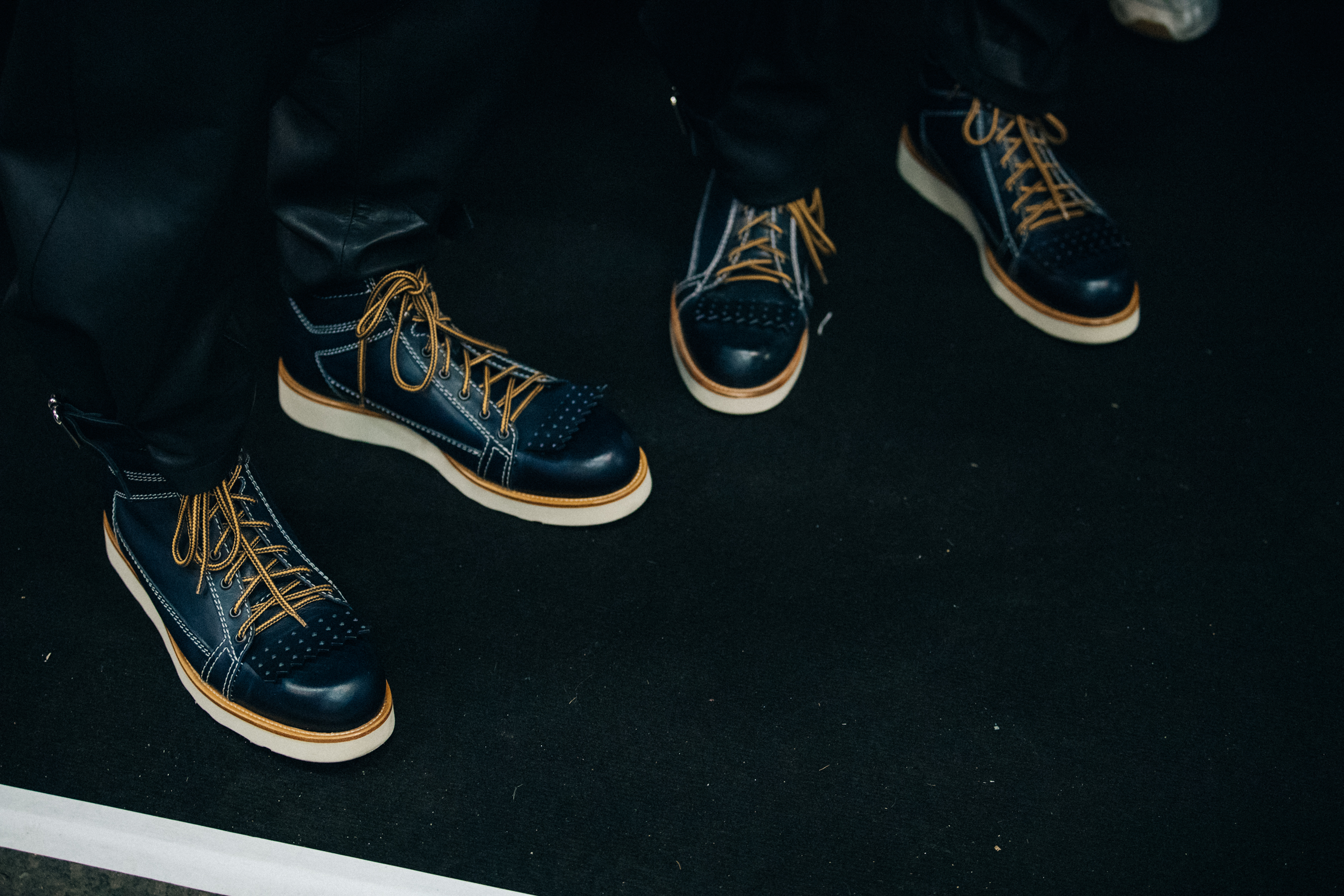 Models wearing leather JW Anderson boots