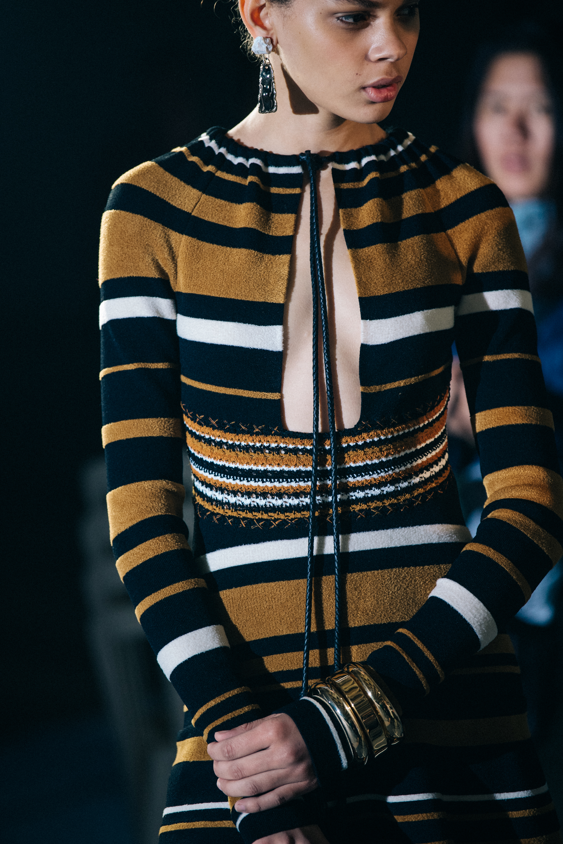 Model wearing orange striped dress