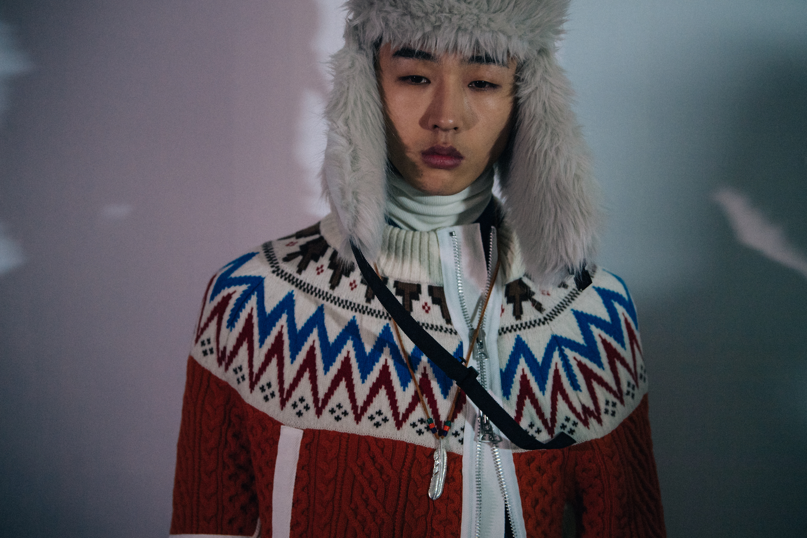 Model wearing furry trapper hat