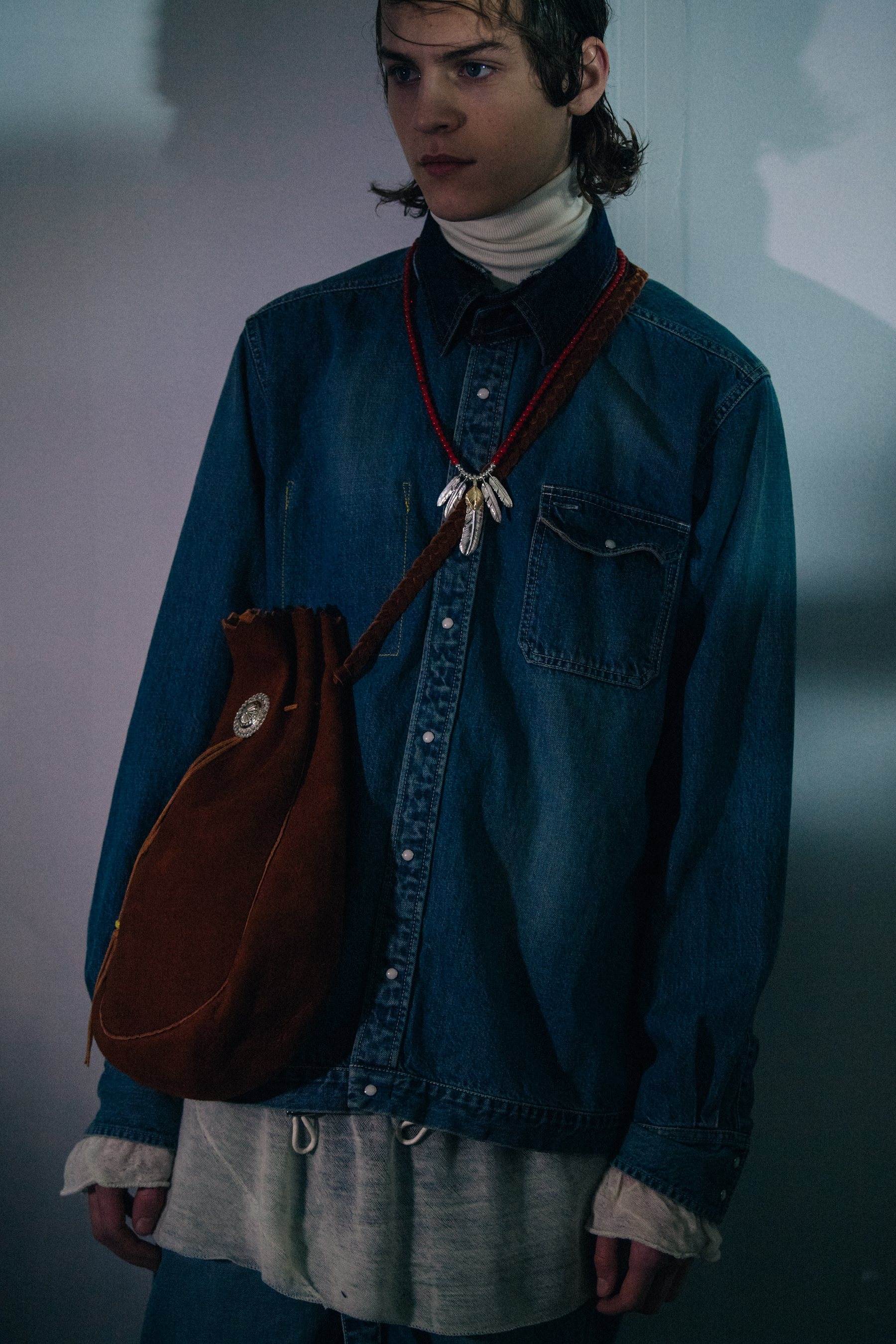 Model wearing denim shirt at Sacai