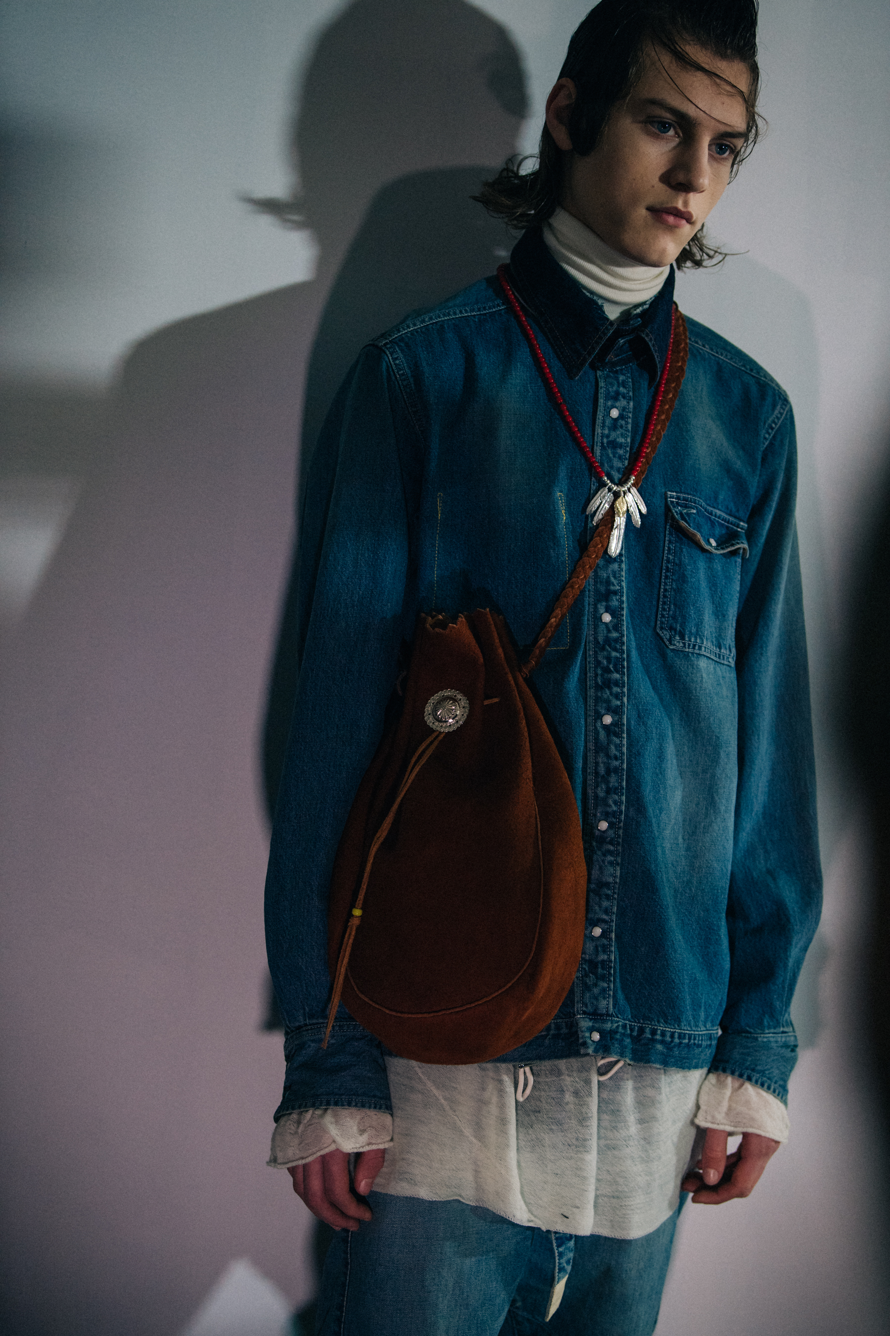 Model wearing denim shirt at Sacai