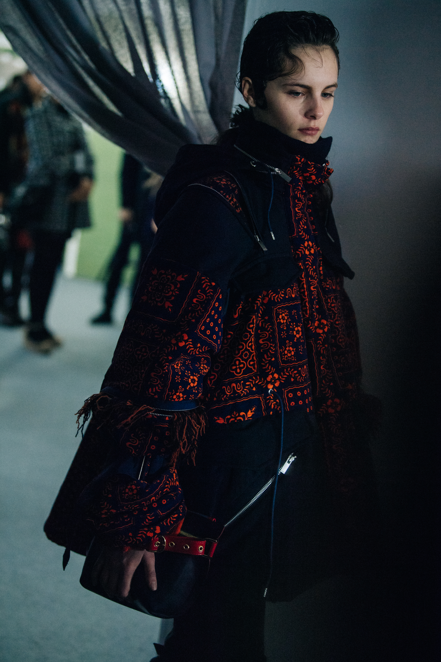 Model wearing red Sacai outfit