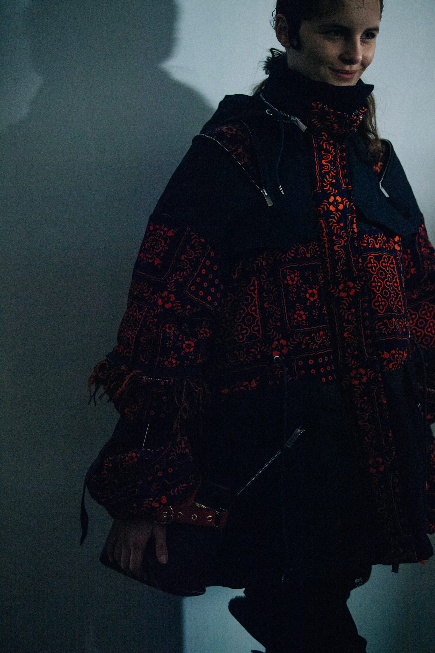 Model wearing red Sacai outfit
