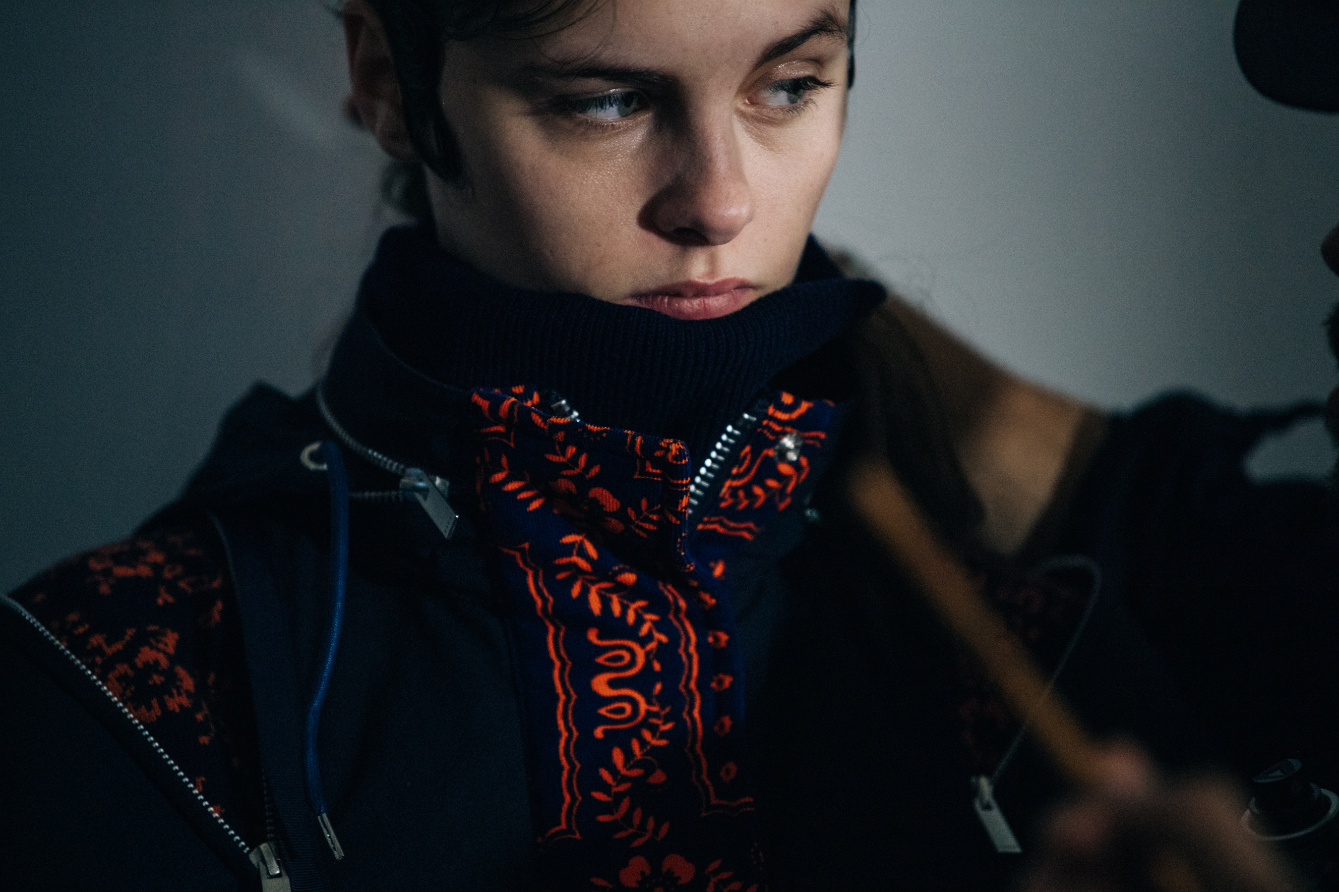 Model wearing red Sacai outfit