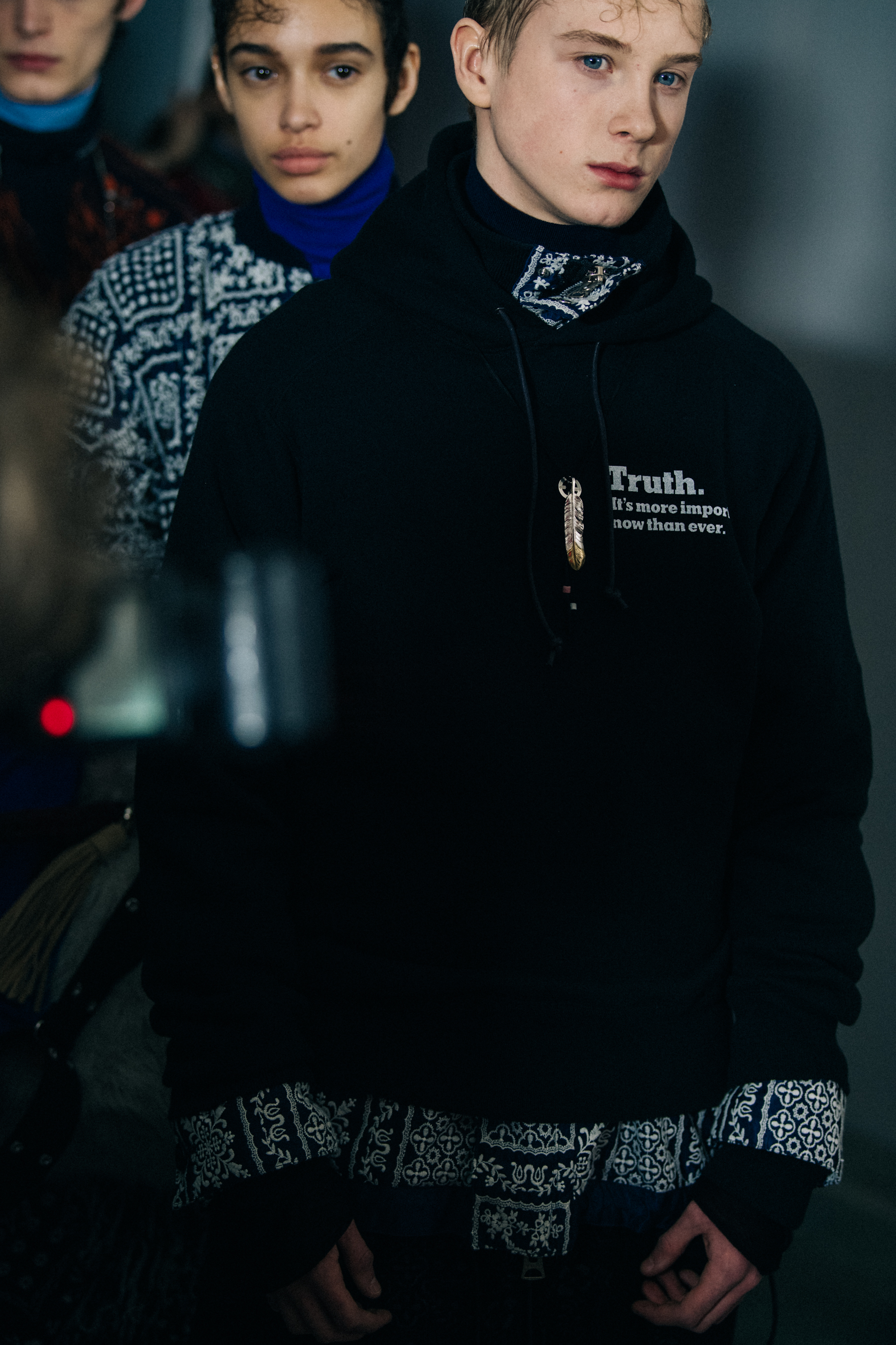Model wearing black Sacai hoodie