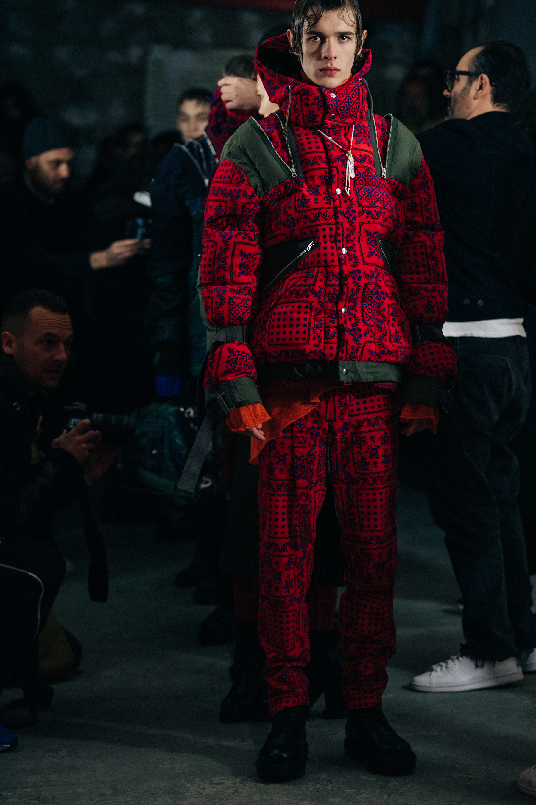 Model wearing red Sacai outfit
