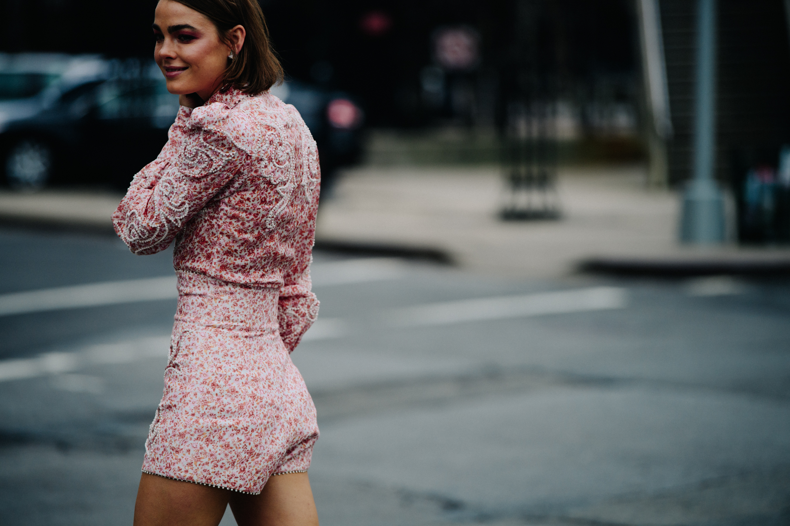 Woman wearing red floral jumpsuit