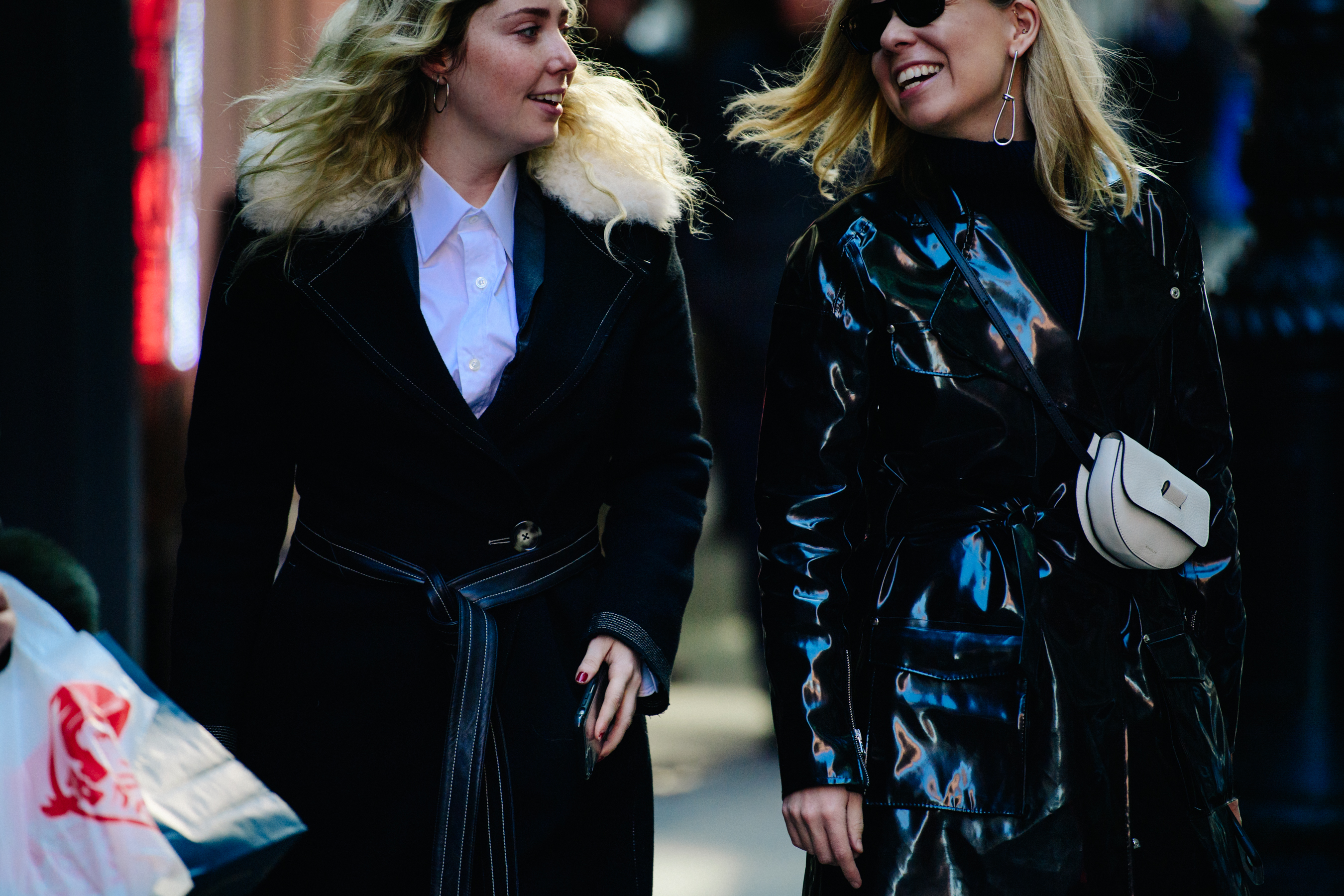 Two women wearing black coats
