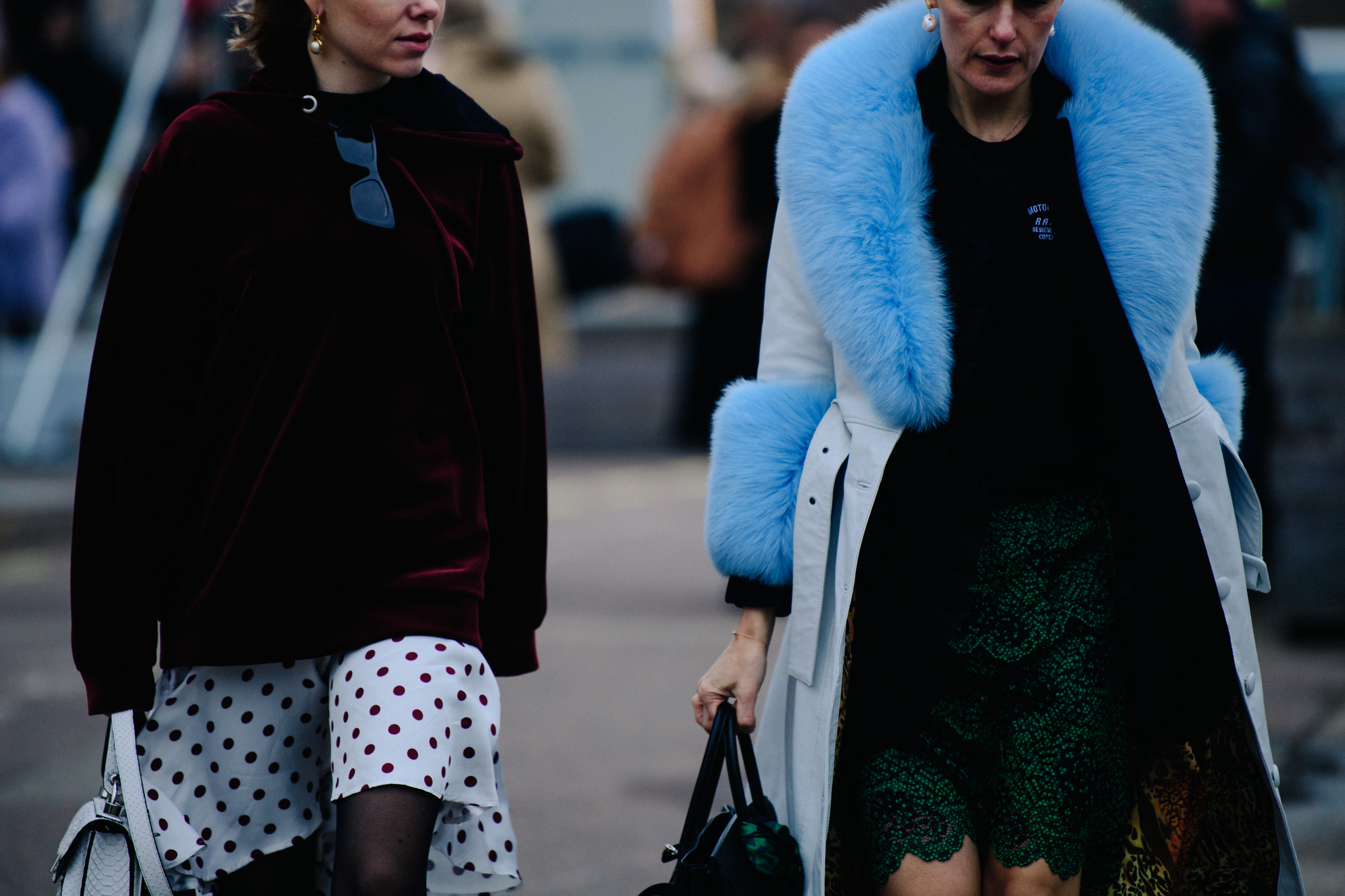 Two women wearing short dresses