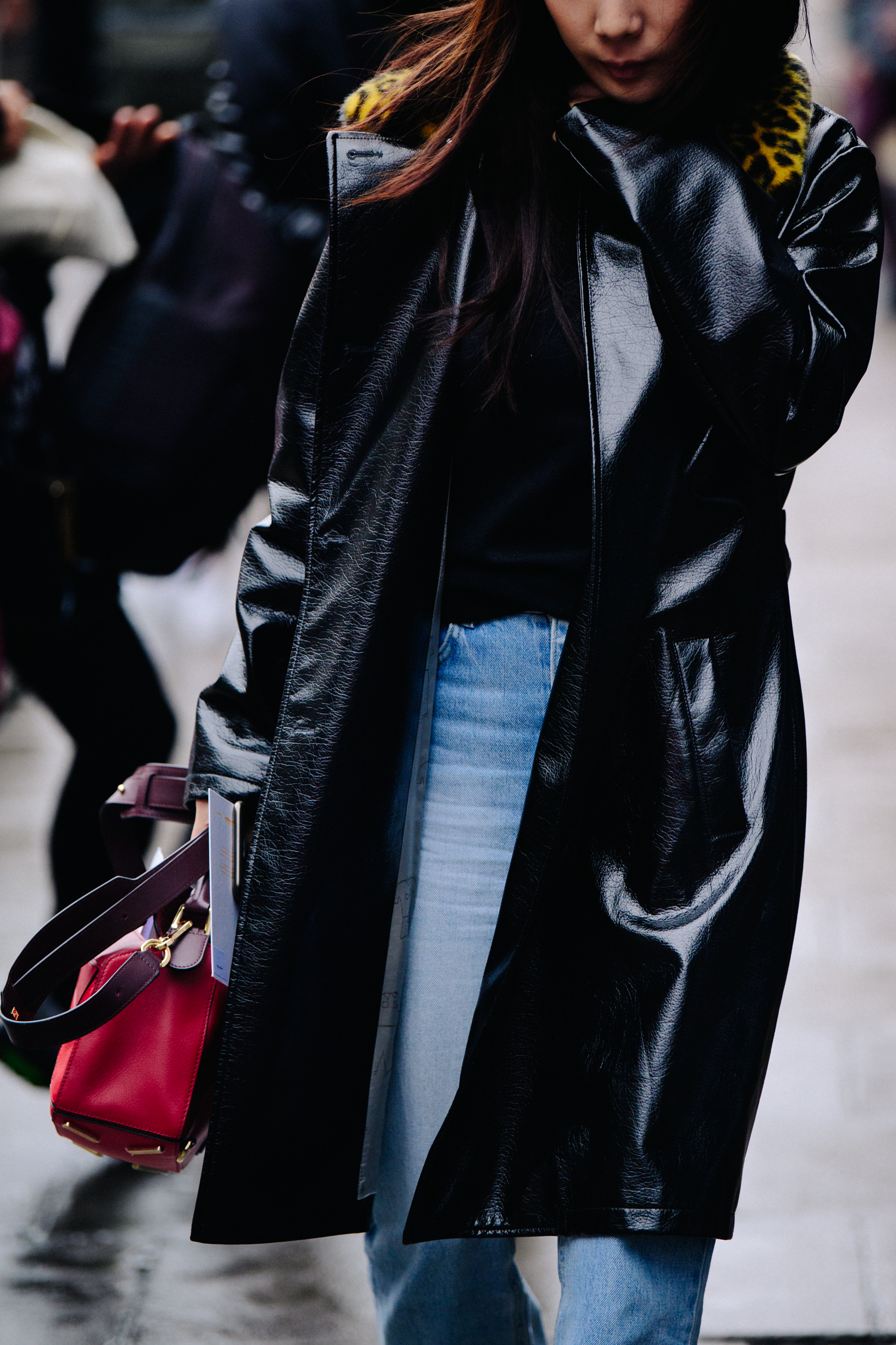 Korean woman wearing black patent coat