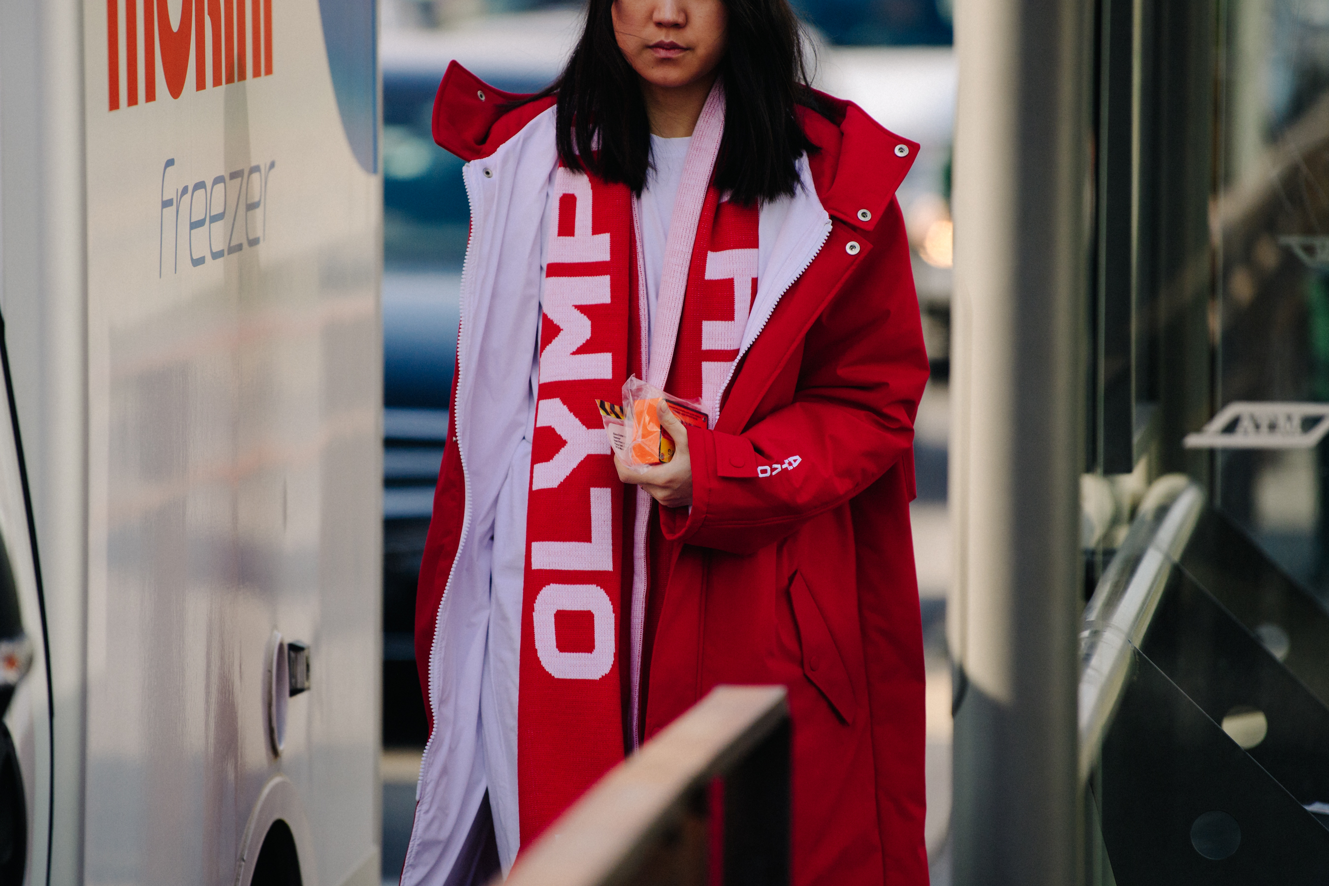 Asian woman wearing red scarf and coat