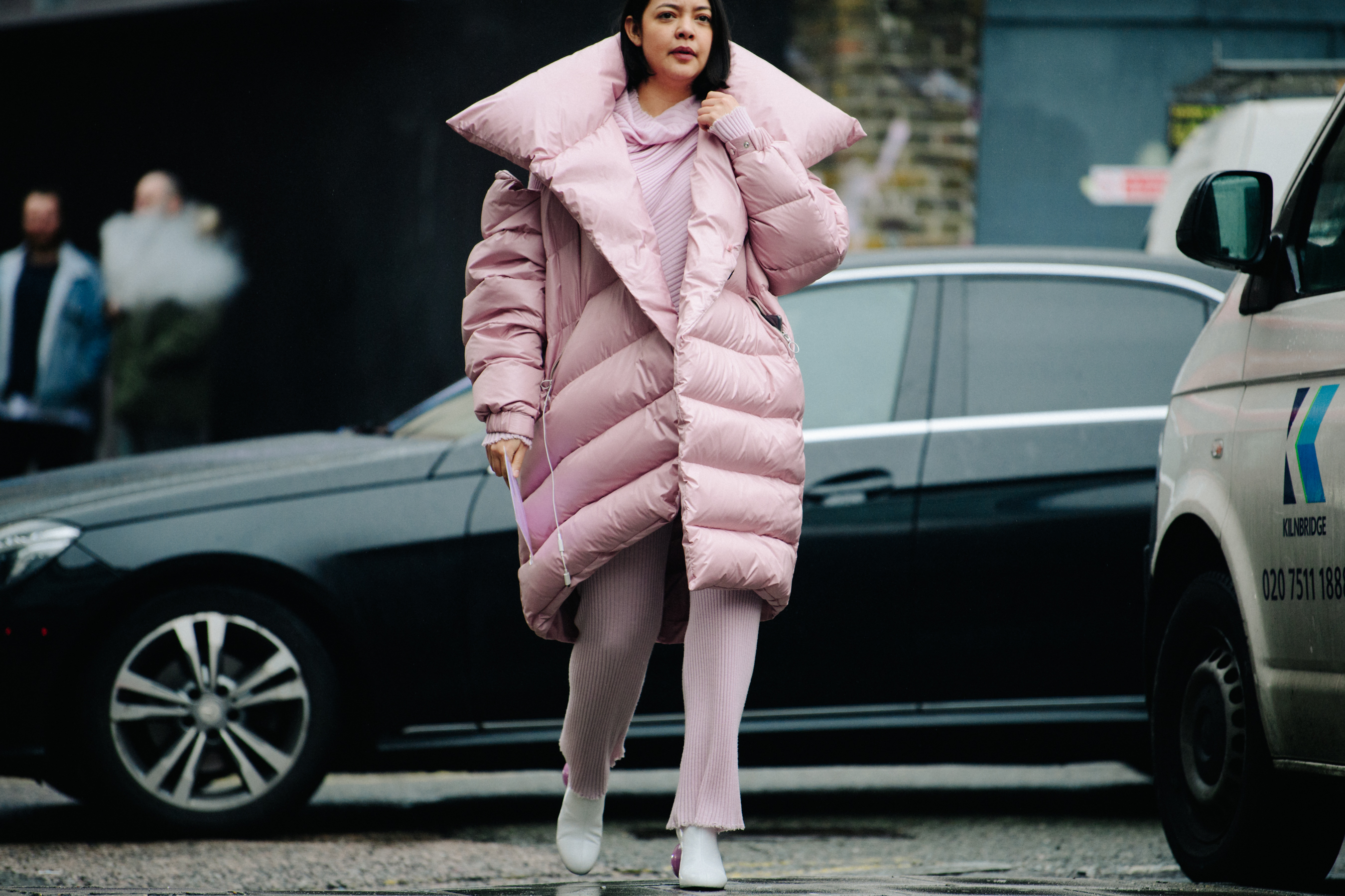 Woman wearing long pink puffer coat