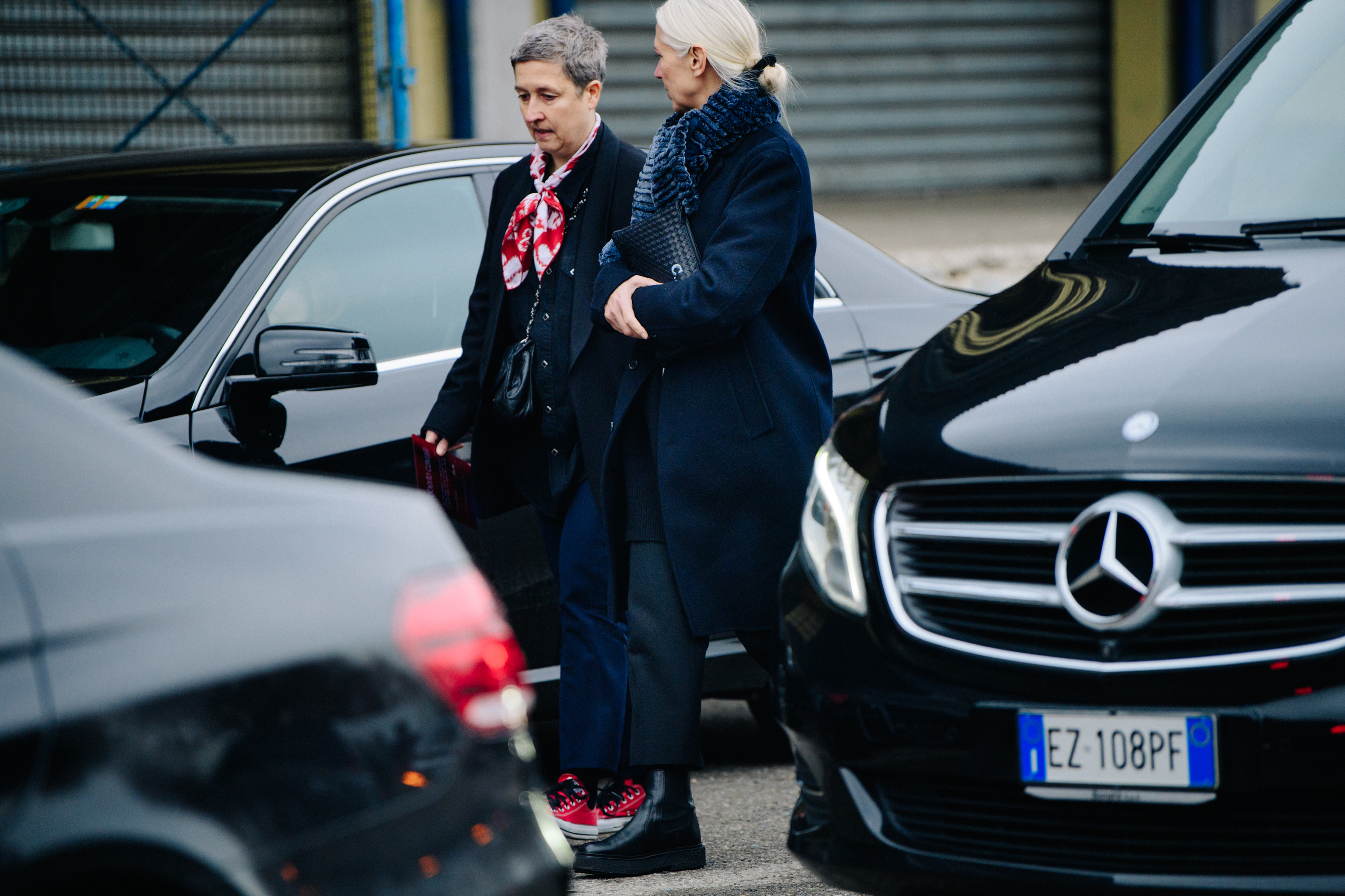 Two women wearing navy outfits