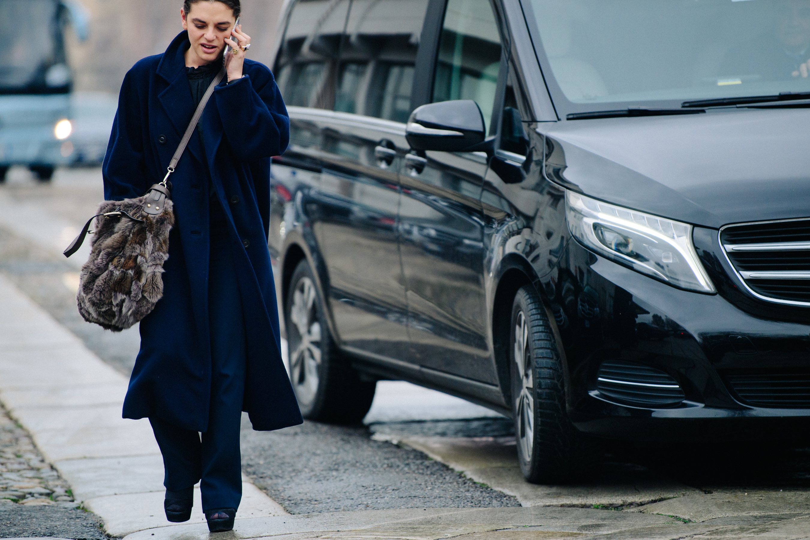 Woman wearing long navy coat