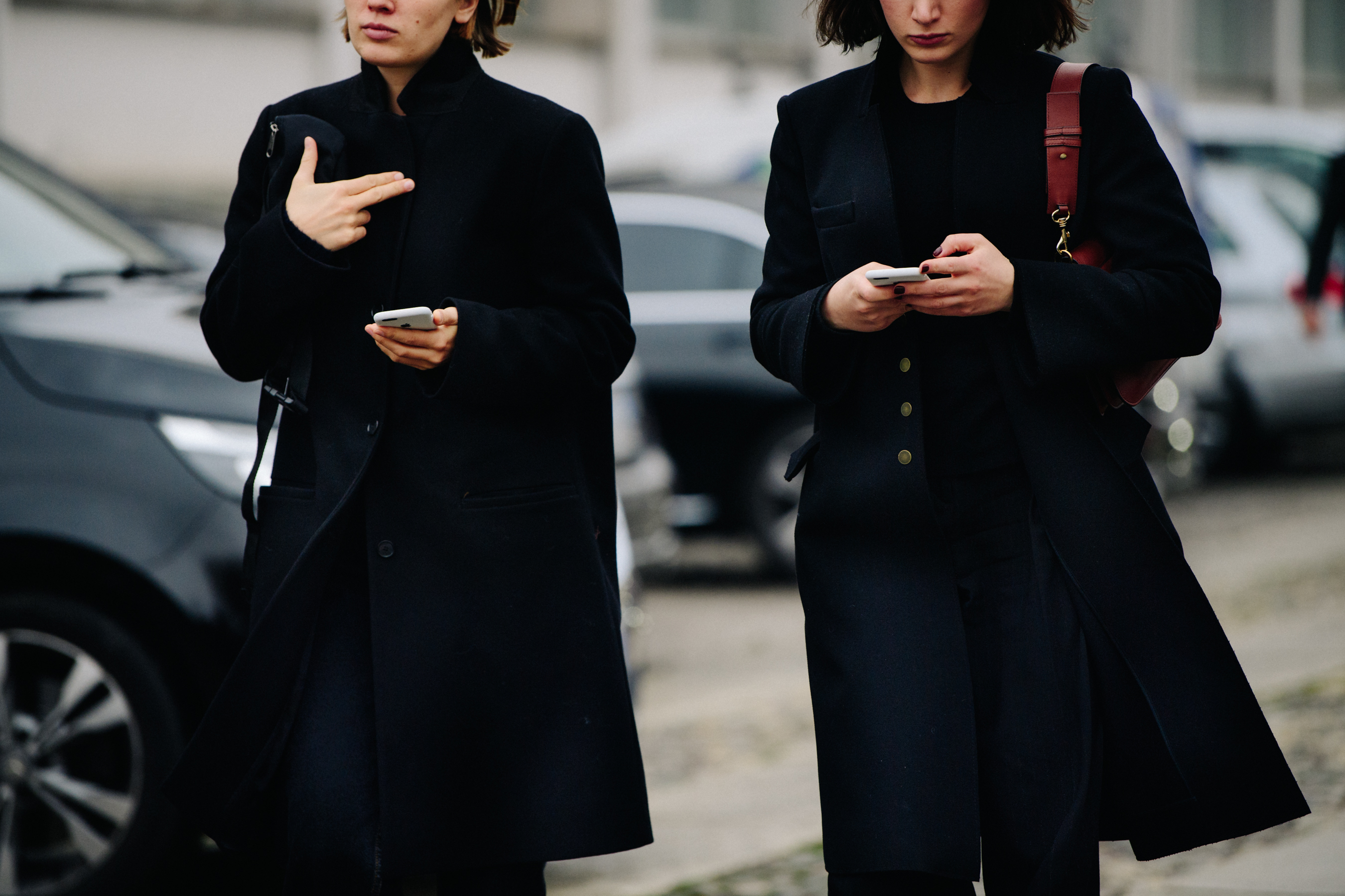 Two women wearing black coats
