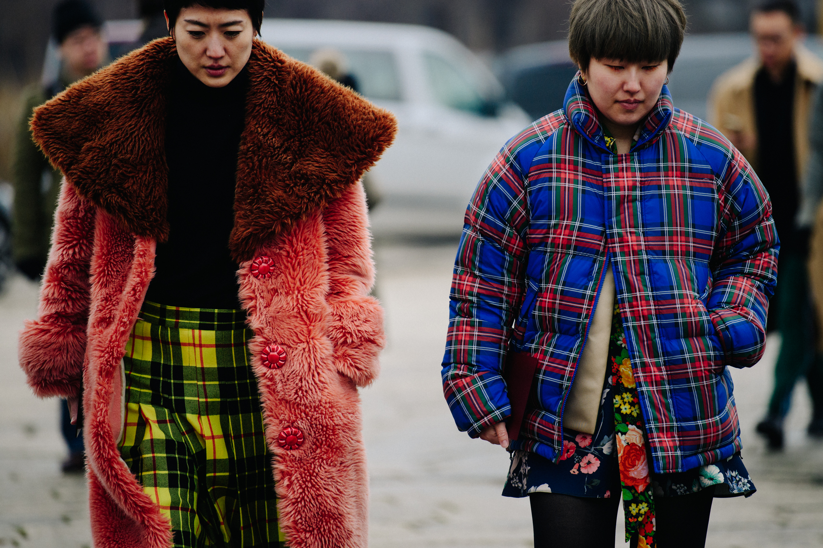 Two Asian women wearing check outfits