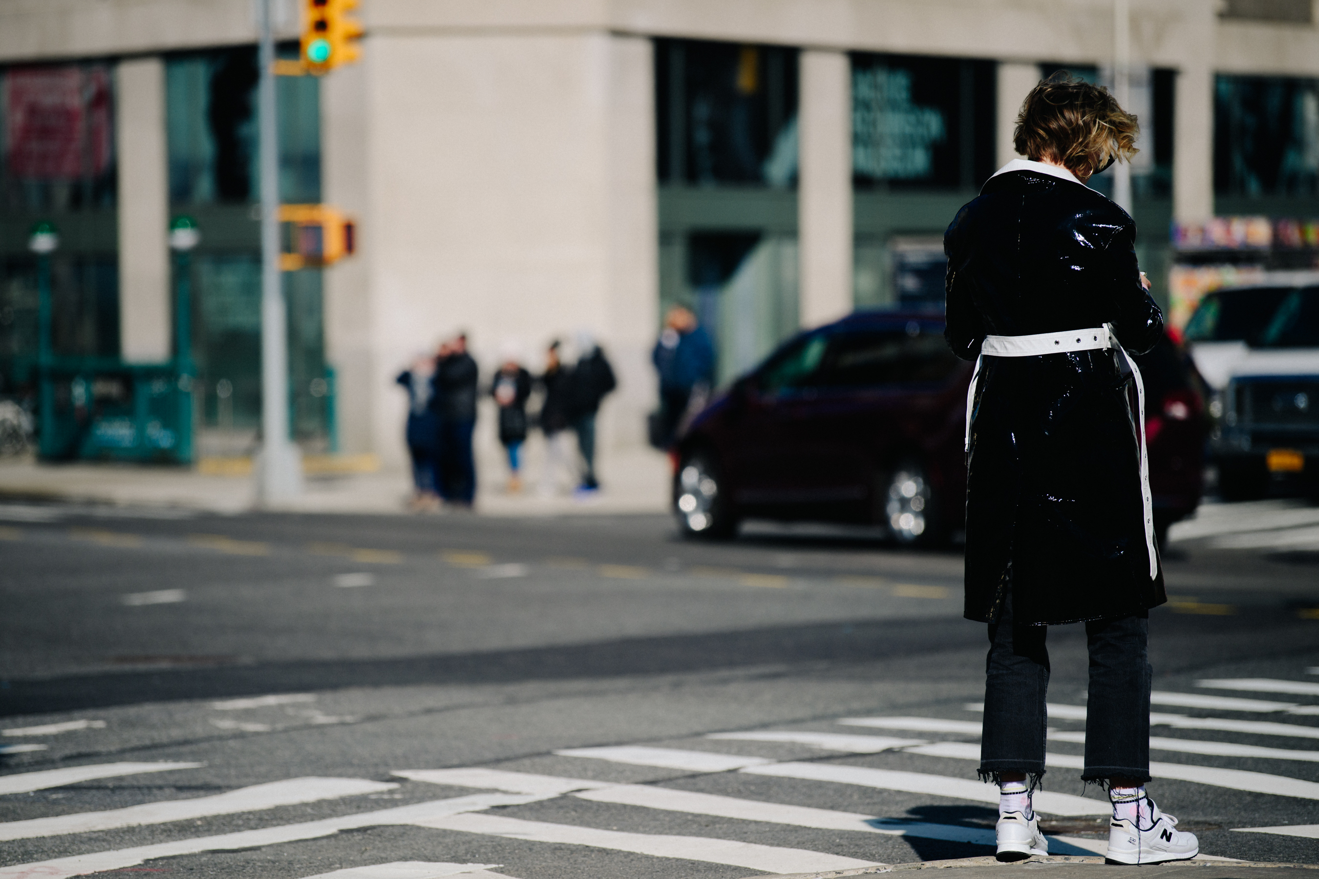 Woman wearing black patent coat