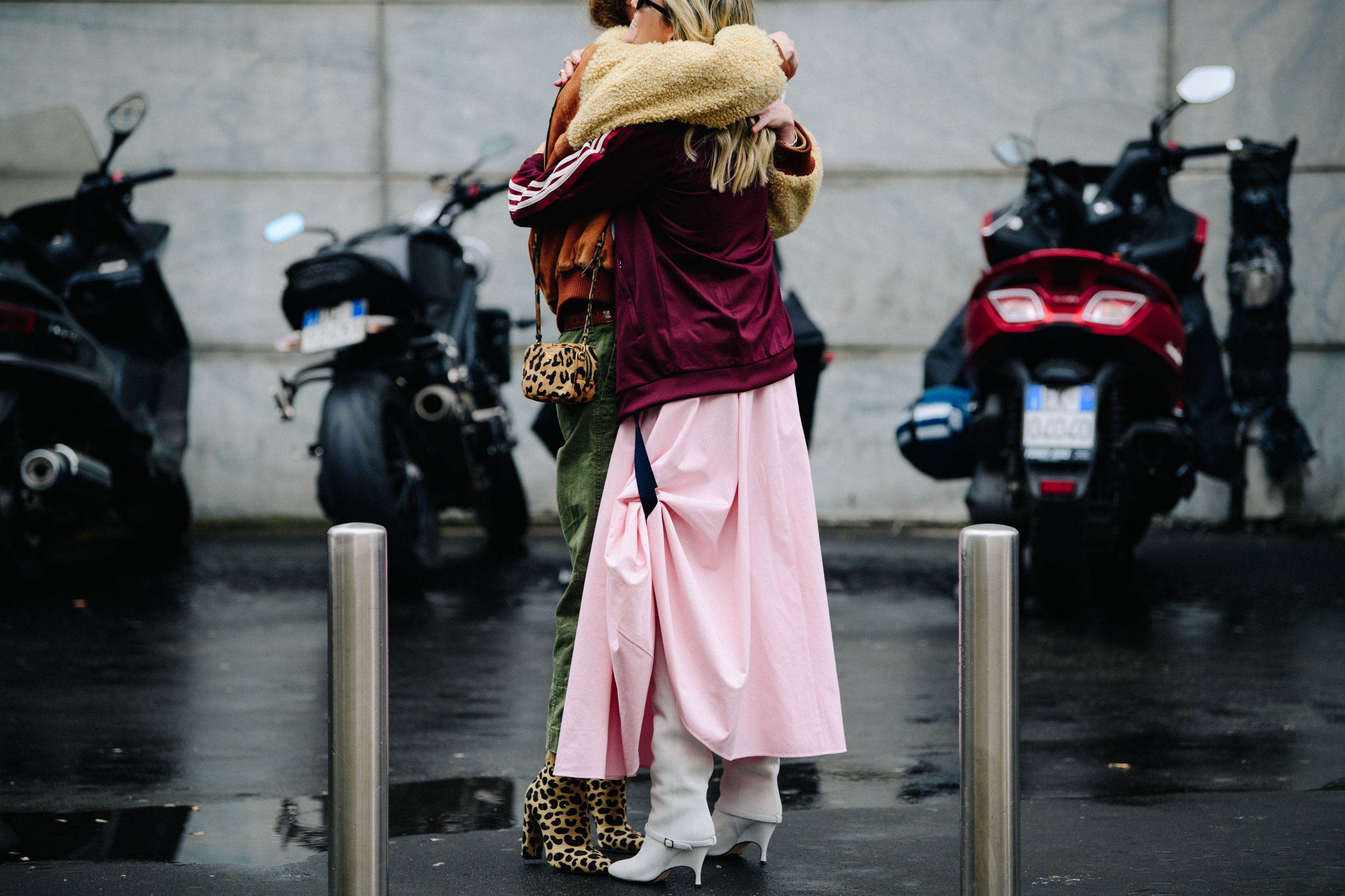Two women hugging in high heel boots