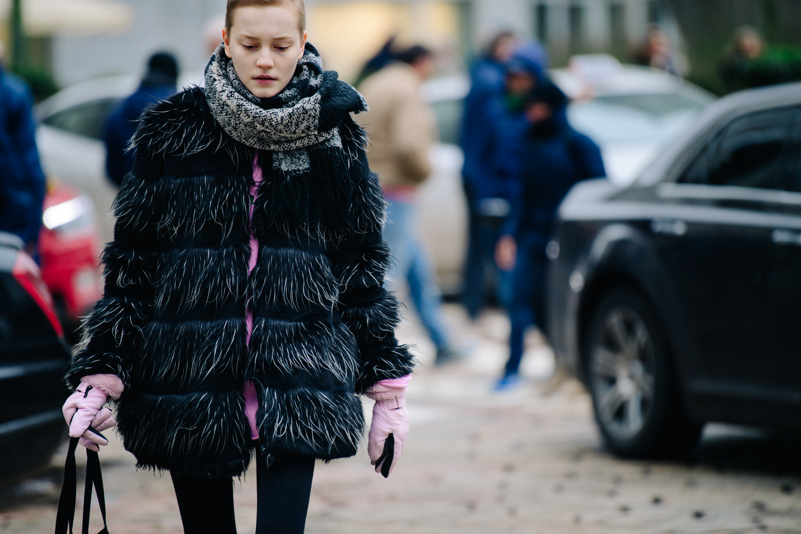 Model wearing black feather coat
