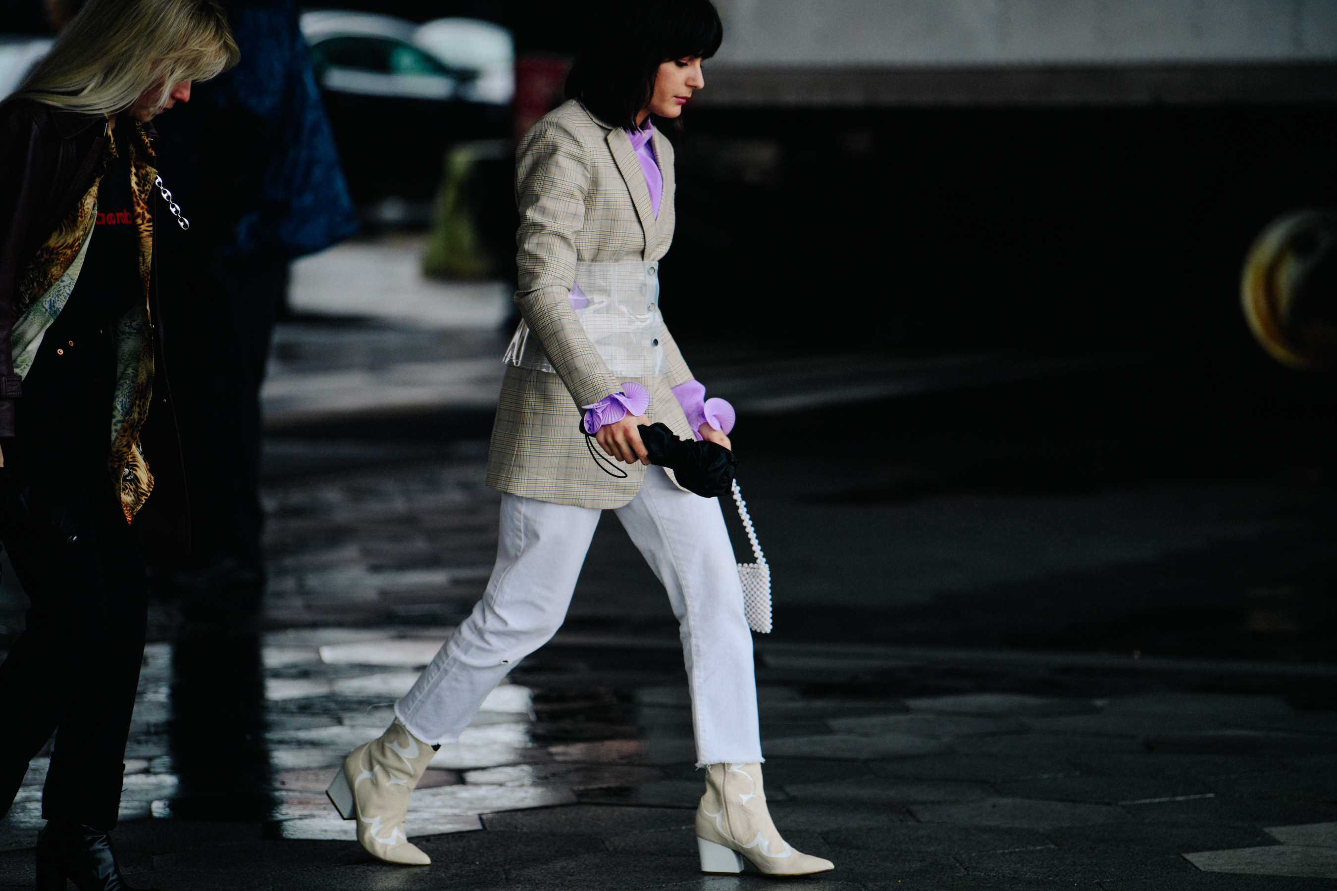 Woman wearing white and purple jacket