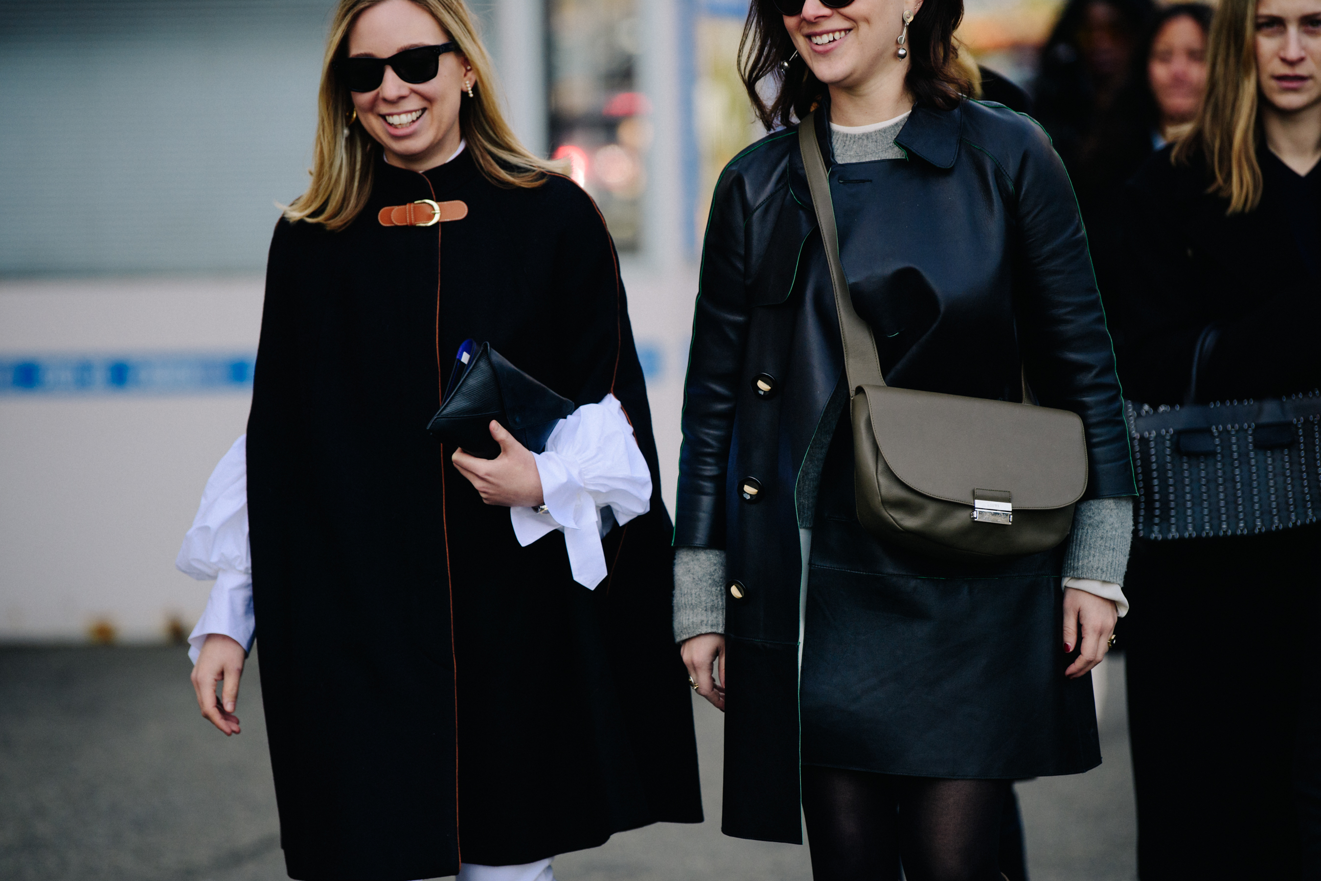 Two women wearing dark winter jackets