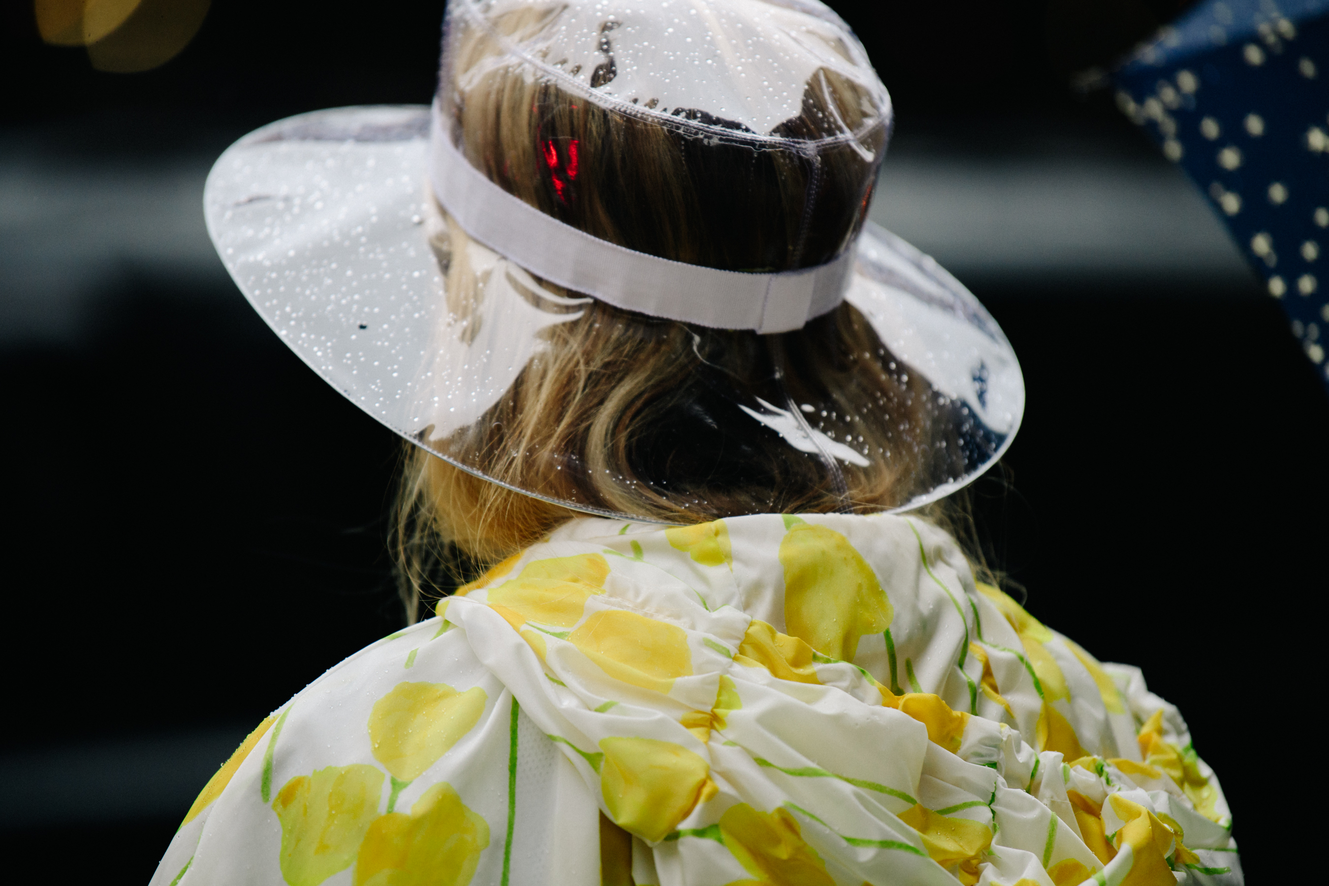 Woman wearing transparent rain hat