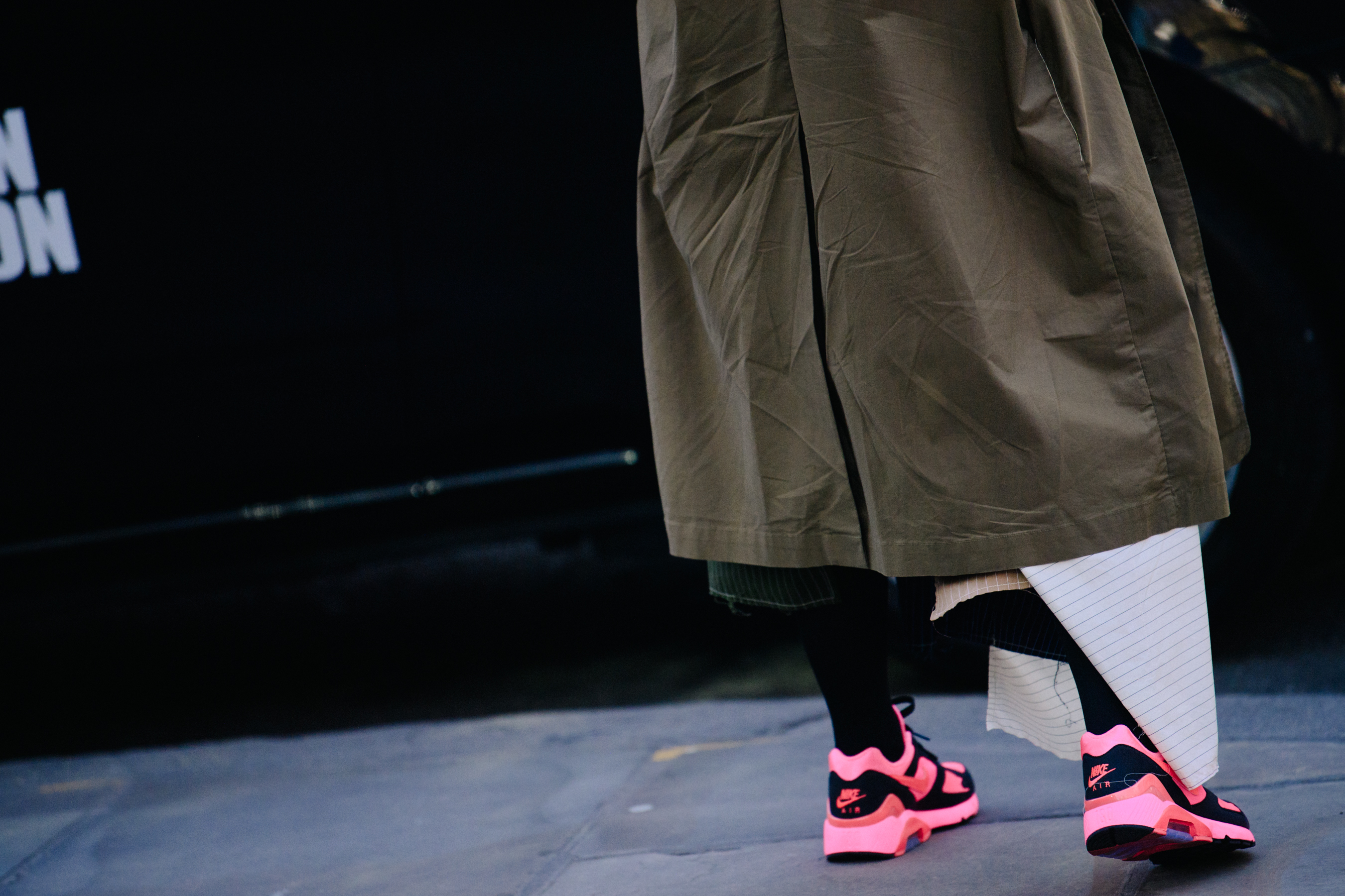 Woman wearing pink Nike sneakers